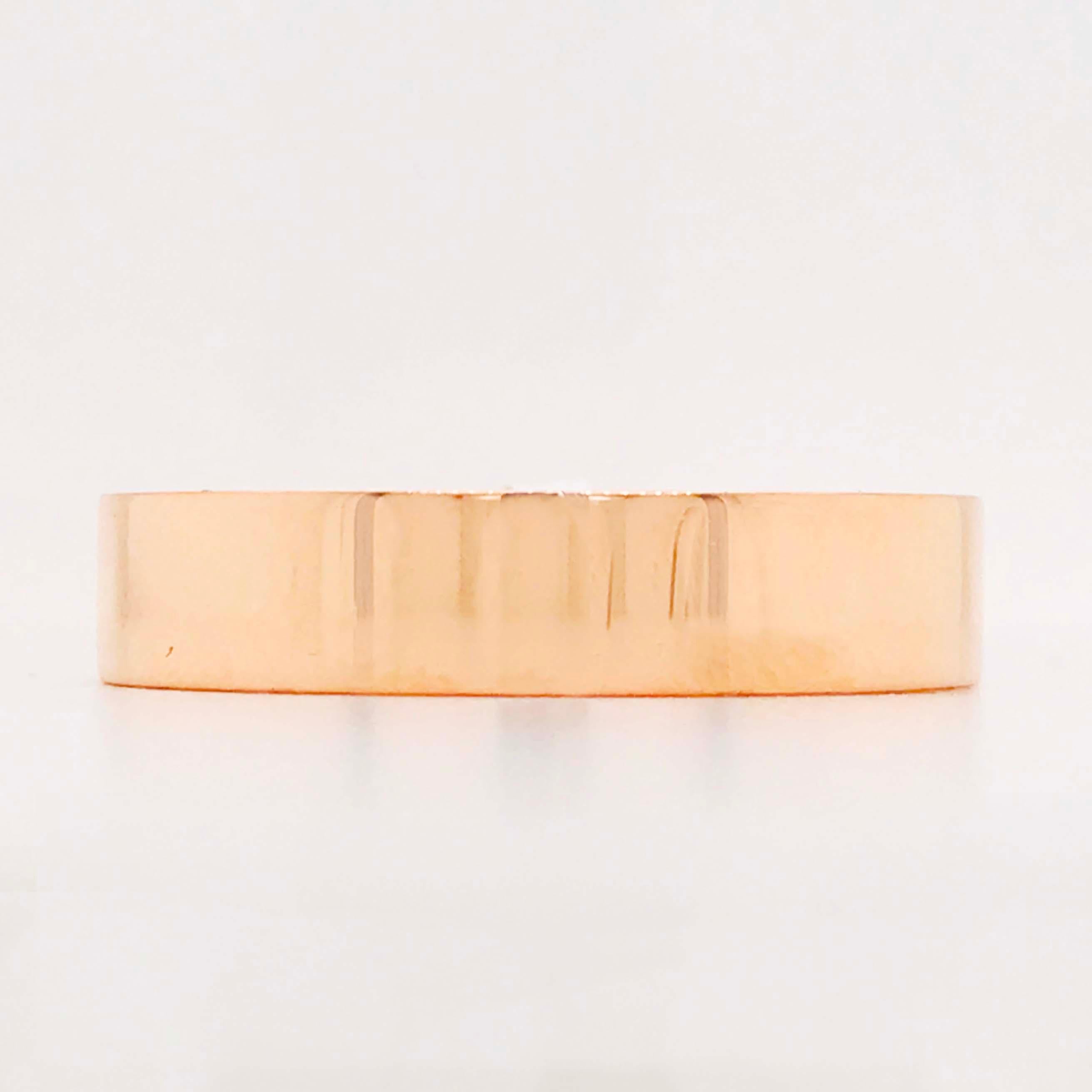 This modern flat 14 karat rose gold band ring is a unique design with a modern structure. The band is a flat style with a high polish finishand looks good on a man or a woman! The band is 5 mm wide and made with a rich 14 karat rose gold! The gold