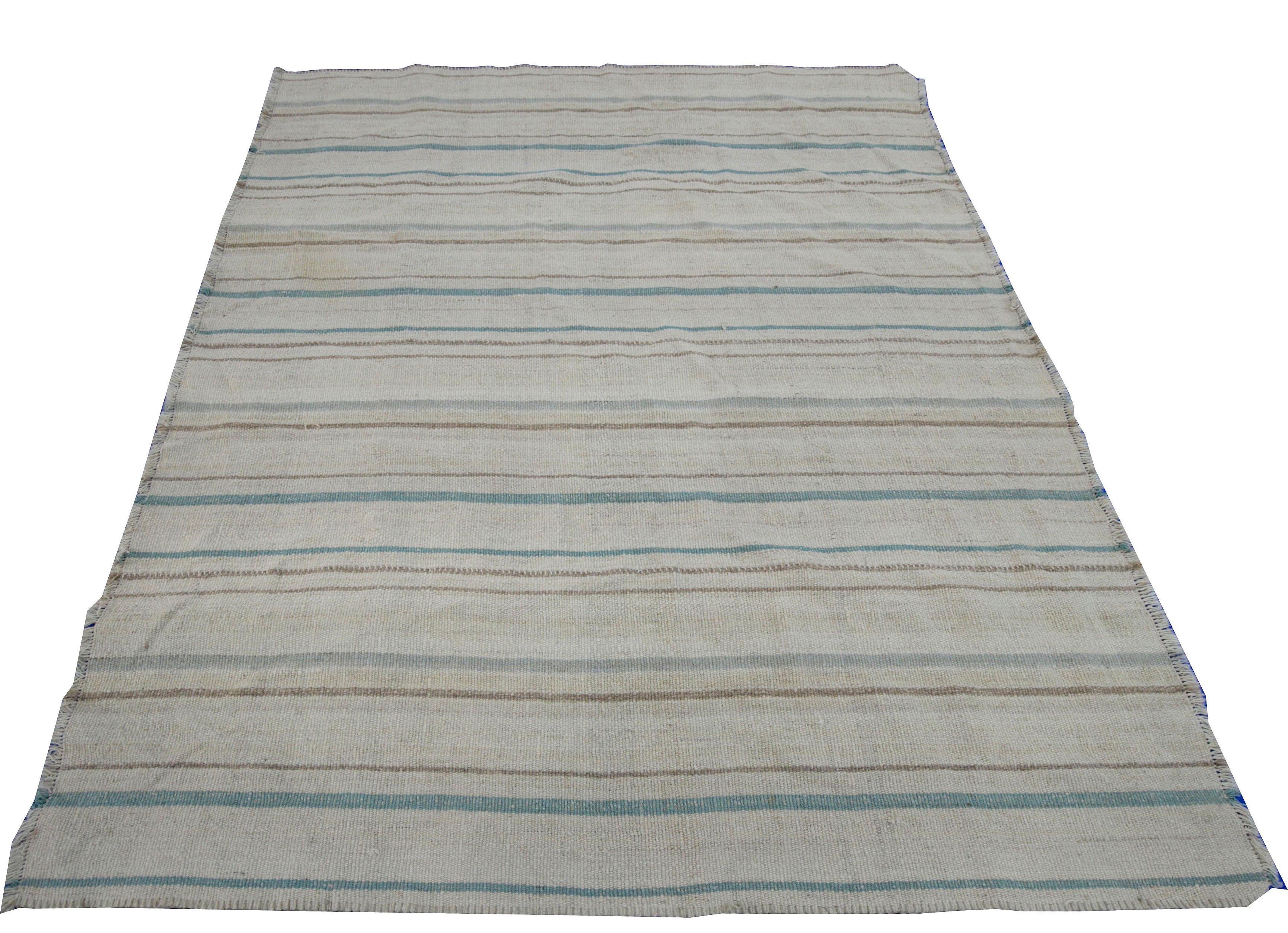 A new production Turkish rug handwoven from the finest sheep’s wool and colored with all-natural vegetable dyes that are safe for humans and pets. It’s a traditional Kilim flat-weave design featuring a beautiful beige field with green and brown