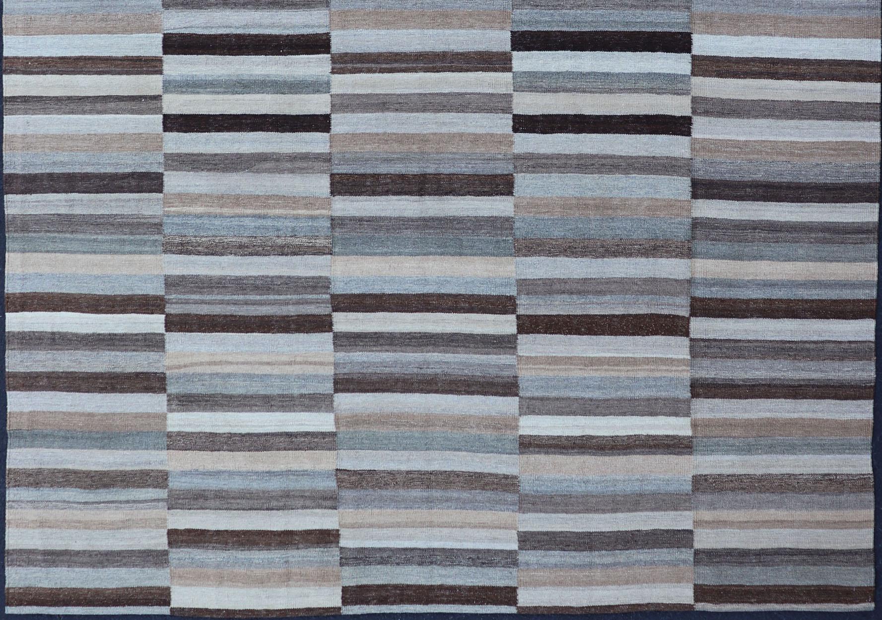 Modern flat-weave Kilim rug with stripes in shades of light ocean blue, charcoal, gray and cream, rug AFG-24713, country of origin / type: Afghanistan / Kilim

This flat-woven kilim rug features a Classic stripe design that places seamlessly in