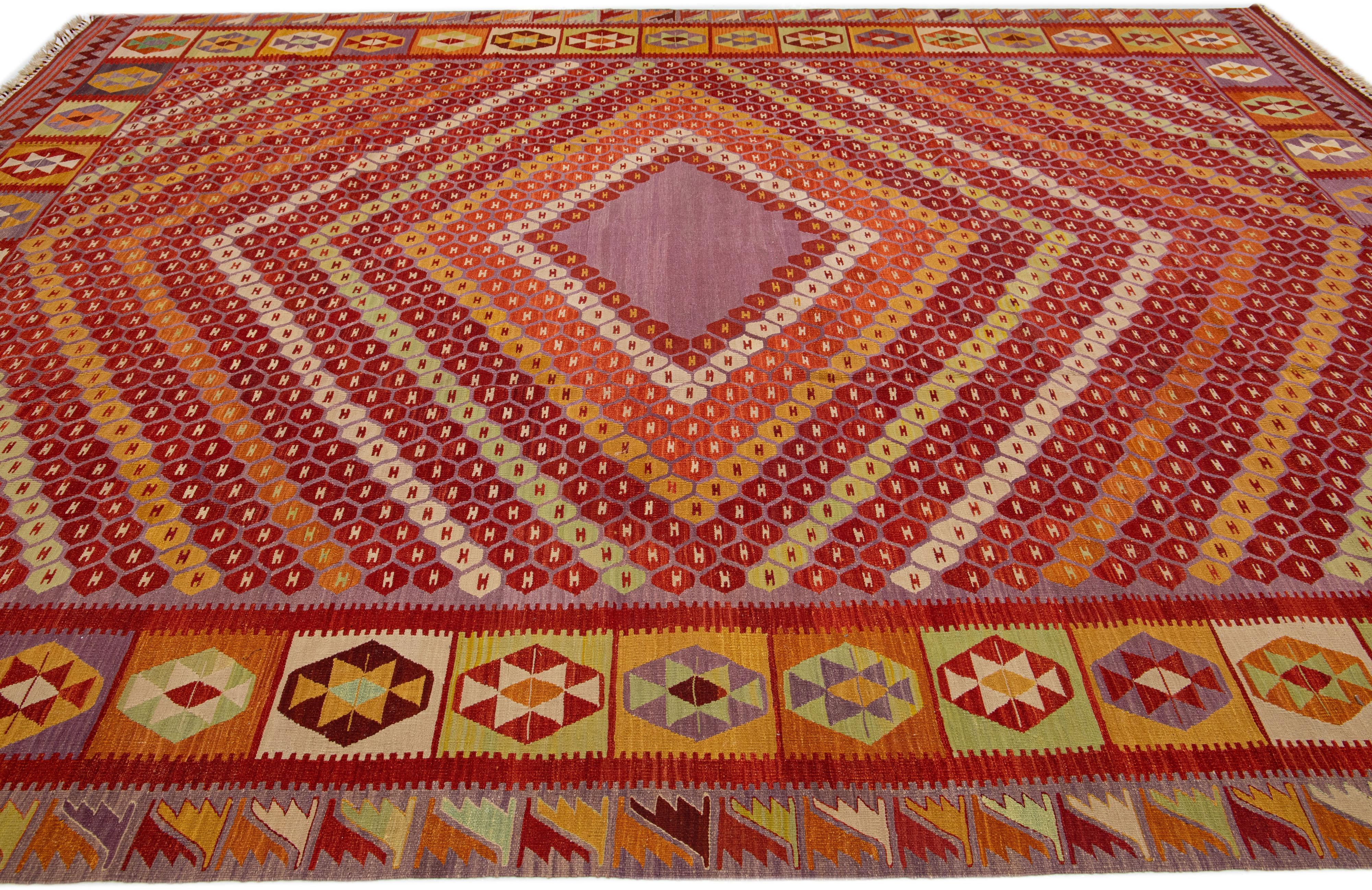 This contemporary kilim flatweave rug of Turkish origin features a colorful and intricate geometric design spread across its entirety.

This rug measures 10'7