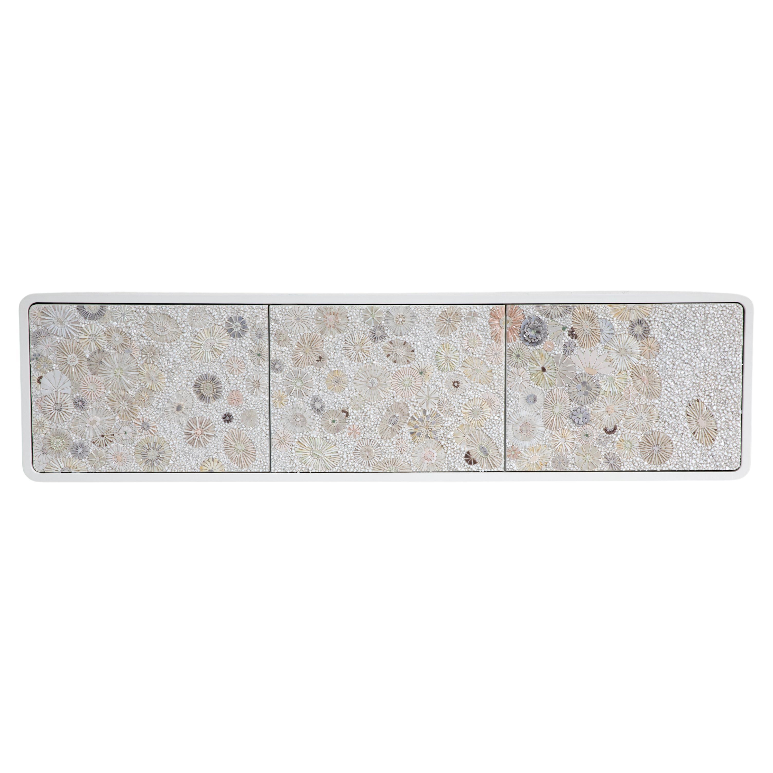 The Modern Floating Blossom 3-Door Buffet is made up of 3 touch latch doors decorated with hand-cut glass in a Blossom Mosaic in shades of Ivory, Grey, Pearl, and Lavender. 

Custom sizing and colors available. Handmade in Brooklyn, New York.
