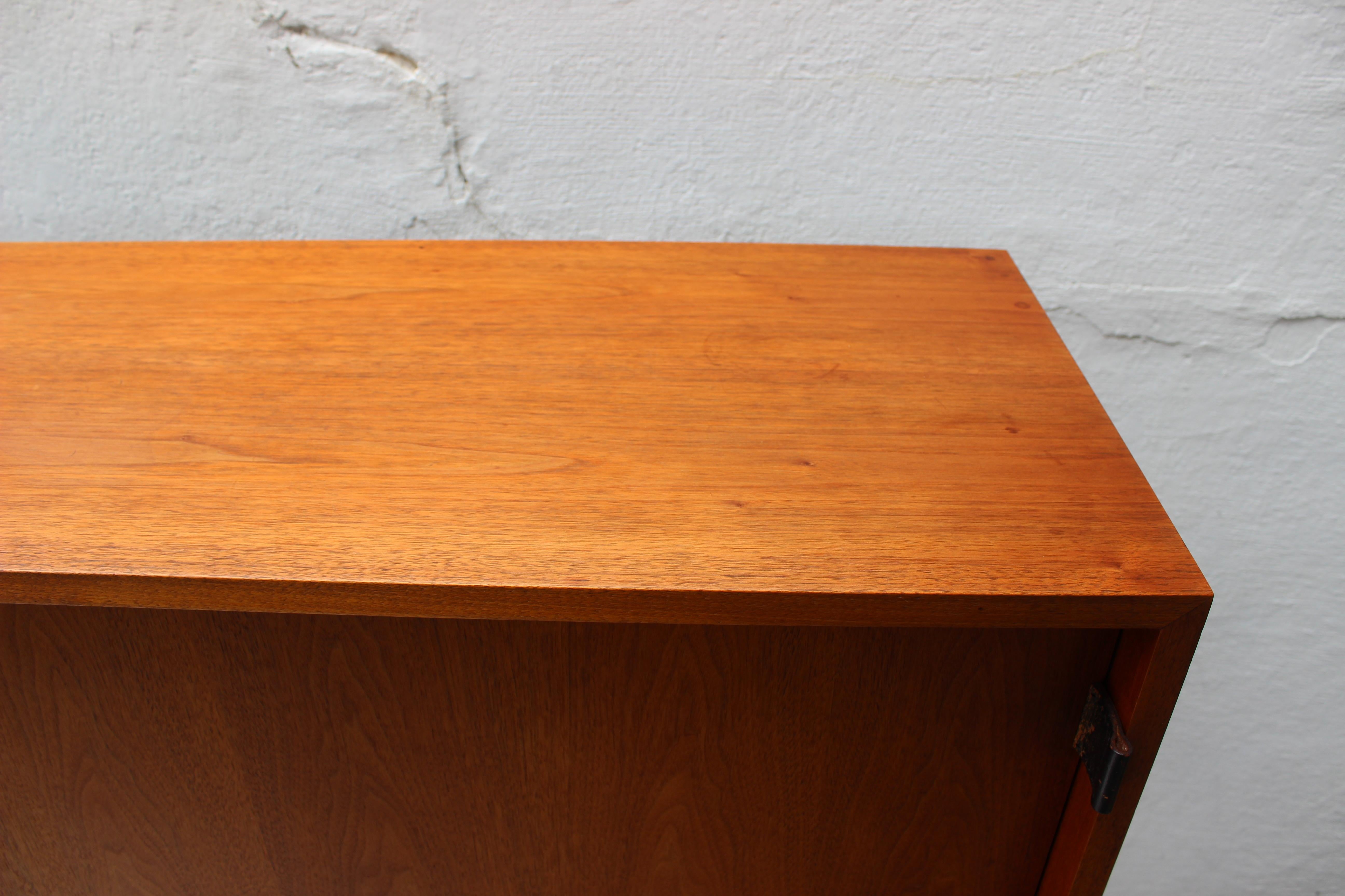 Mid-Century Modern Florence Knoll floating wall mount walnut credenza, sideboard or storage unit.

Label still present on the back of the piece.