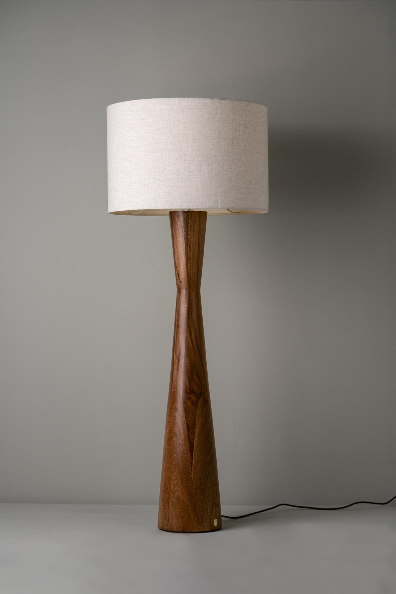 TULIPÁN floor lamp was designed for the De Palo collection by Mexican artist Isabel Moncada.

Made in Parota, the two inverted overlapping cones give Tulipán a shape that suggests a quite charming female proportion. Its broad and robust fiberglass