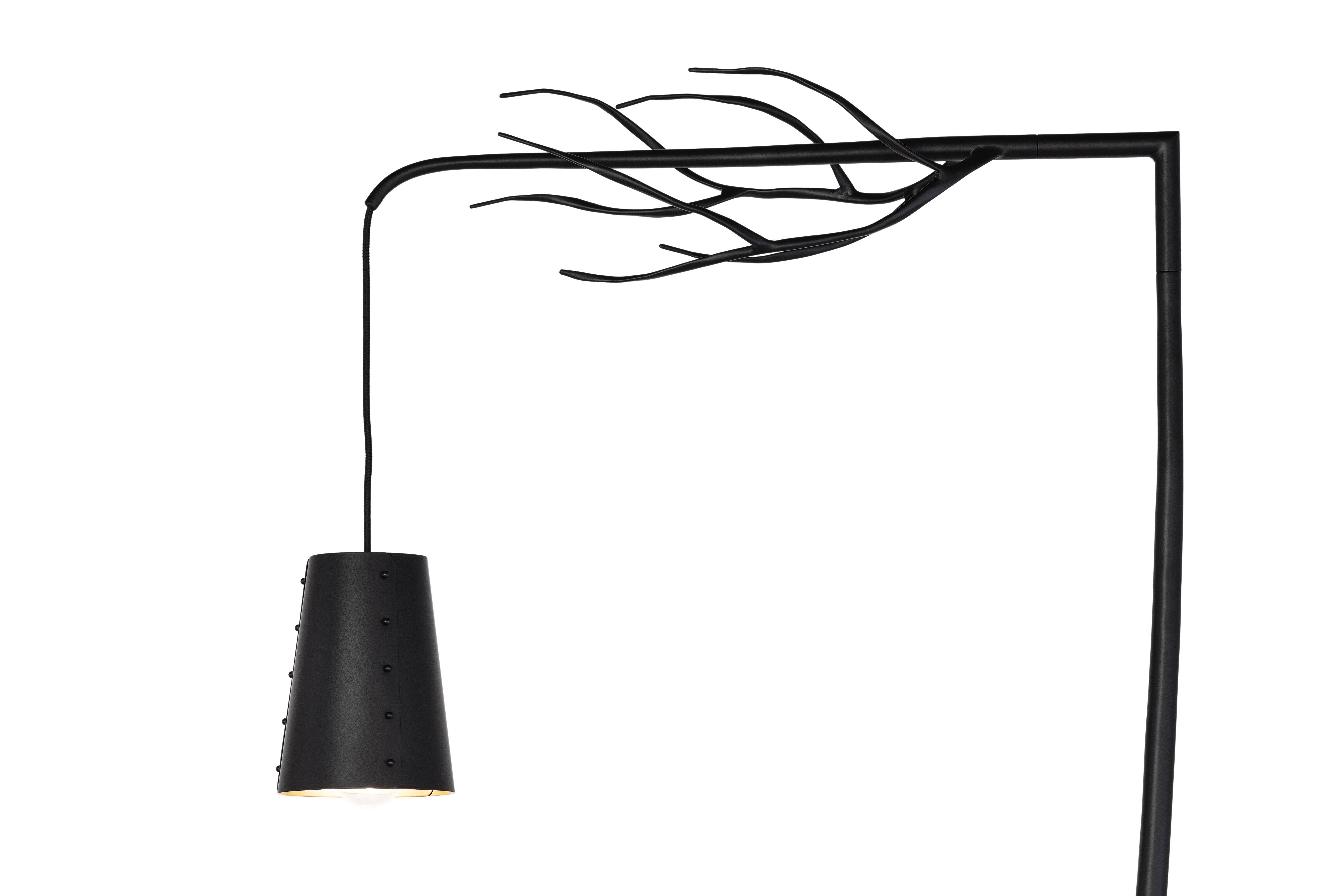 The Flintstone is a modern floor lamp in a black matt finish designed by Wiliam Brand of Brand van Egmond. 

Retracing our steps through the millennia to the beginning of times, we find ourselves back at the fireplace in the prehistoric cave. Here