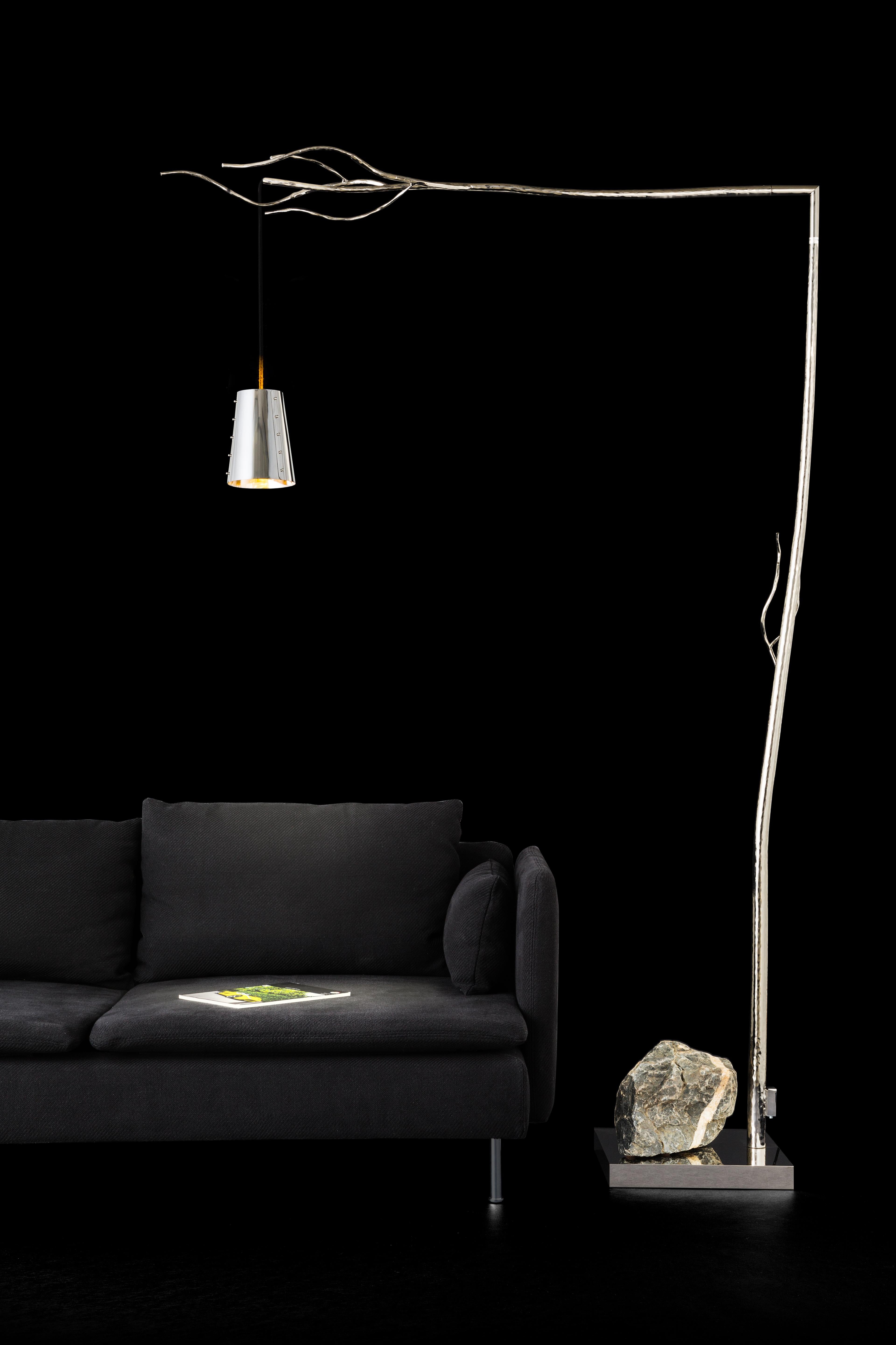 The Flintstone is a modern floor lamp in a nickel finish designed by Wiliam Brand, founder of Brand van Egmond. 

Retracing our steps through the millennia to the beginning of times, we find ourselves back at the fireplace in the prehistoric cave.