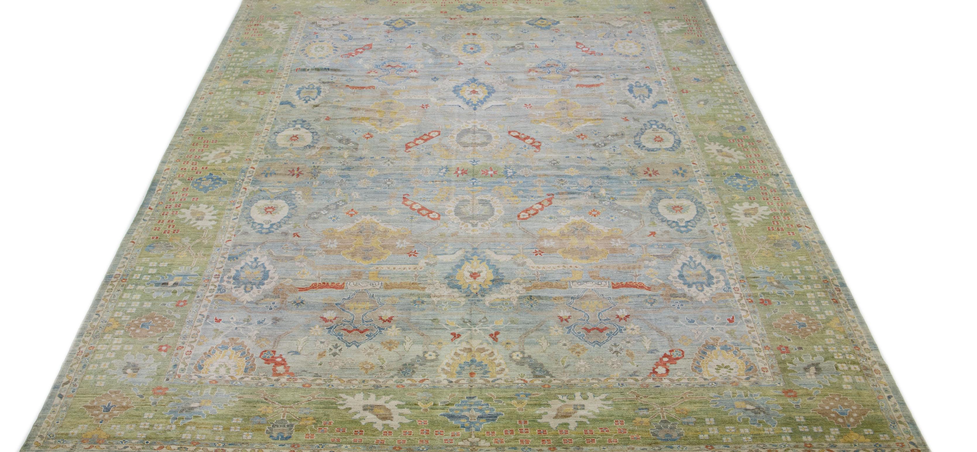This contemporary take on the traditional Sultanabad style is showcased in an exquisite hand-knotted wool rug with a striking light blue color. An intricately designed frame accentuates its all-over floral motif, adorned with multicolored accents
