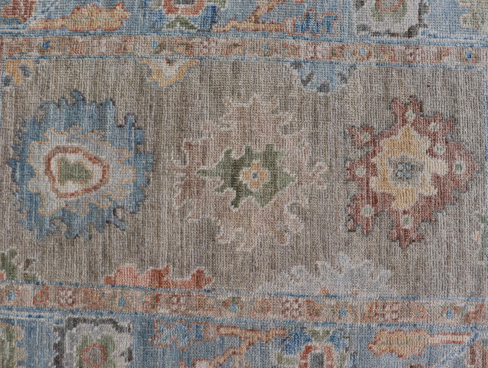 Measures: 2'7 x 4'0 
Modern Floral Oushak With Sandy-Brown Background and A Sky Blue Border. Keivan Woven Arts; rug AWR-12378 Country of Origin: Afghanistan Type: Oushak Design: Floral, Arabesque, All-Over. 

This piece gives a modern vibrancy to