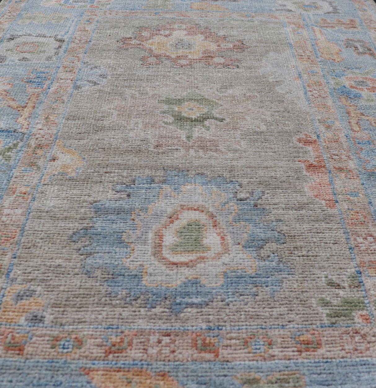 Wool Modern Floral Oushak With Sandy-Brown Background and A Sky Blue Border For Sale
