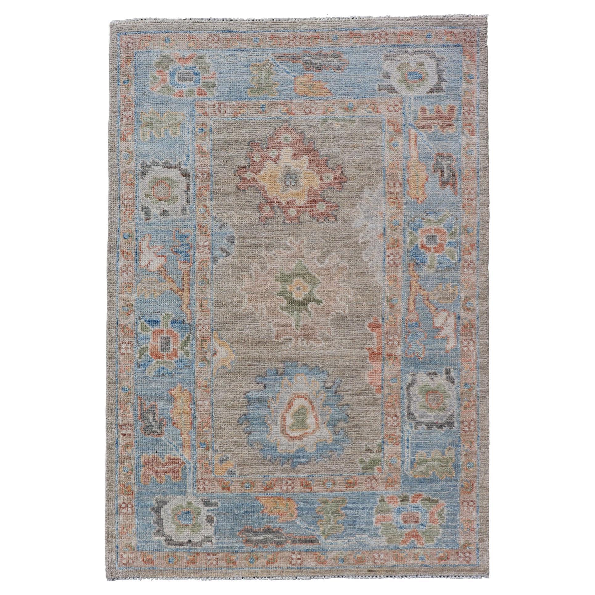 Modern Floral Oushak With Sandy-Brown Background and A Sky Blue Border For Sale