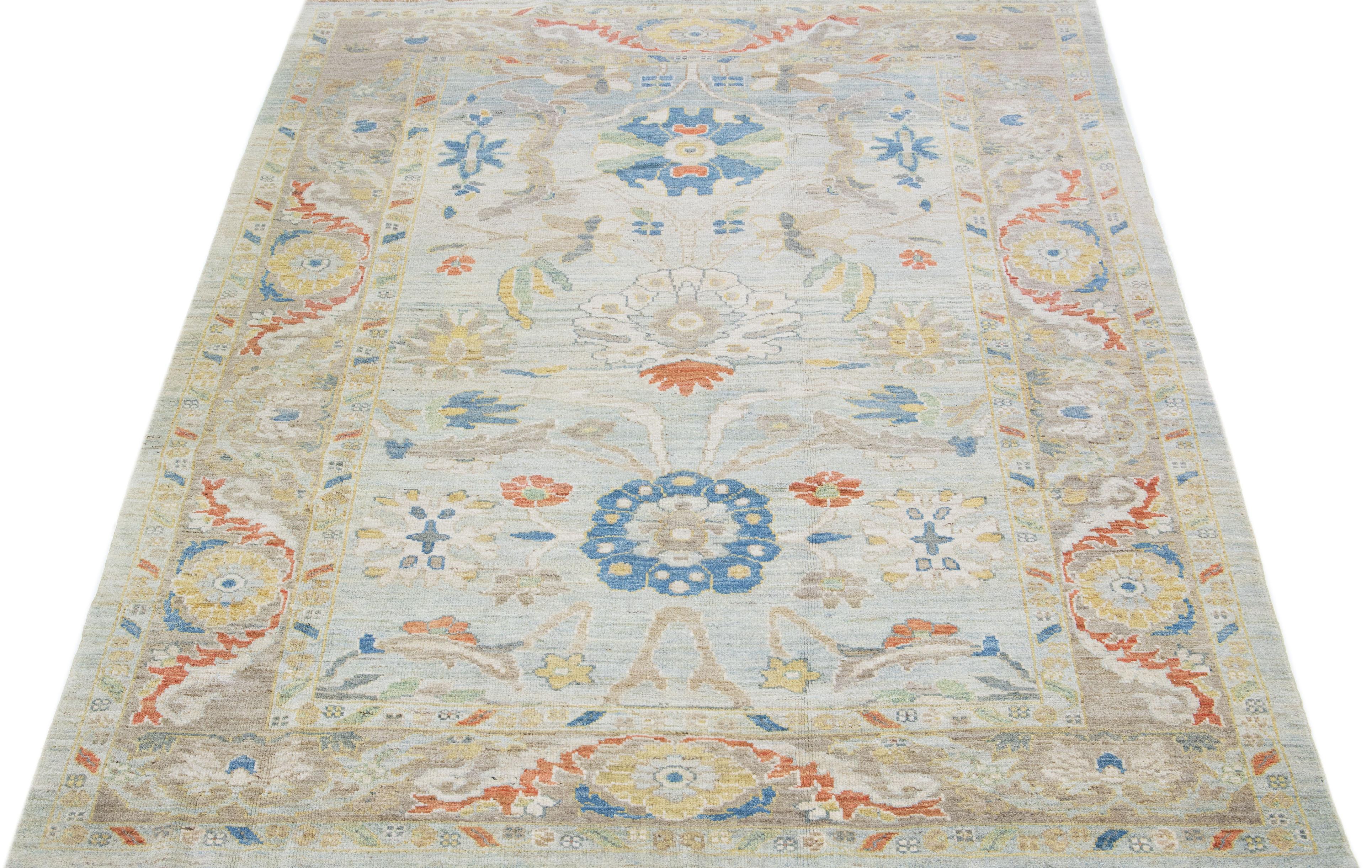 Beautiful modern Sultanabad hand knotted wool rug with a light blue color field. This rug has a beige-designed frame with multicolor accents in a gorgeous all-over floral design.

This rug measures: 6'10