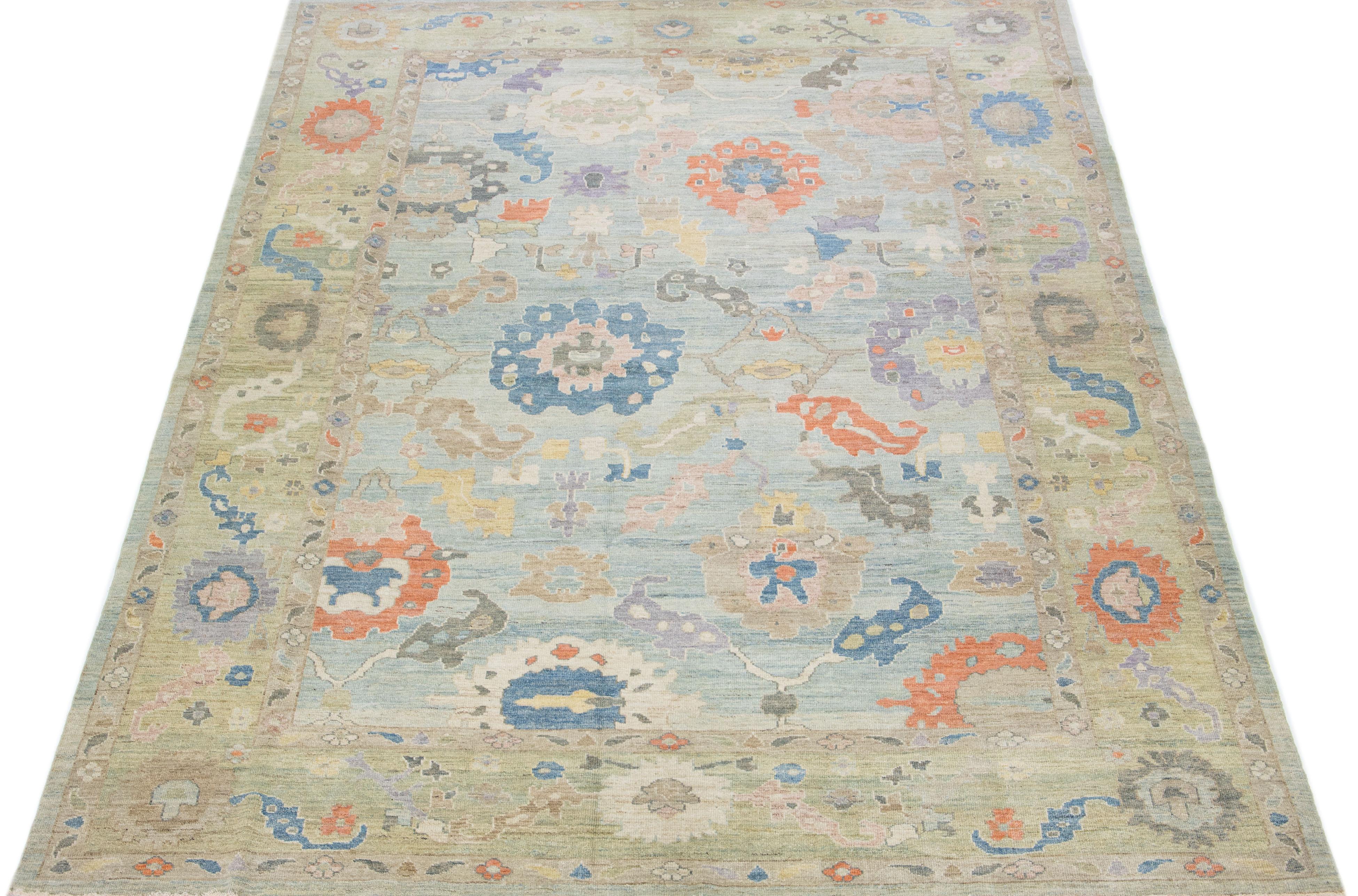 Beautiful modern sultanabad hand-knotted wool rug with a blue color field. This rug has a green-designed frame with multicolor accents in a gorgeous all-over floral design.

This rug measures: 10' x 14'6