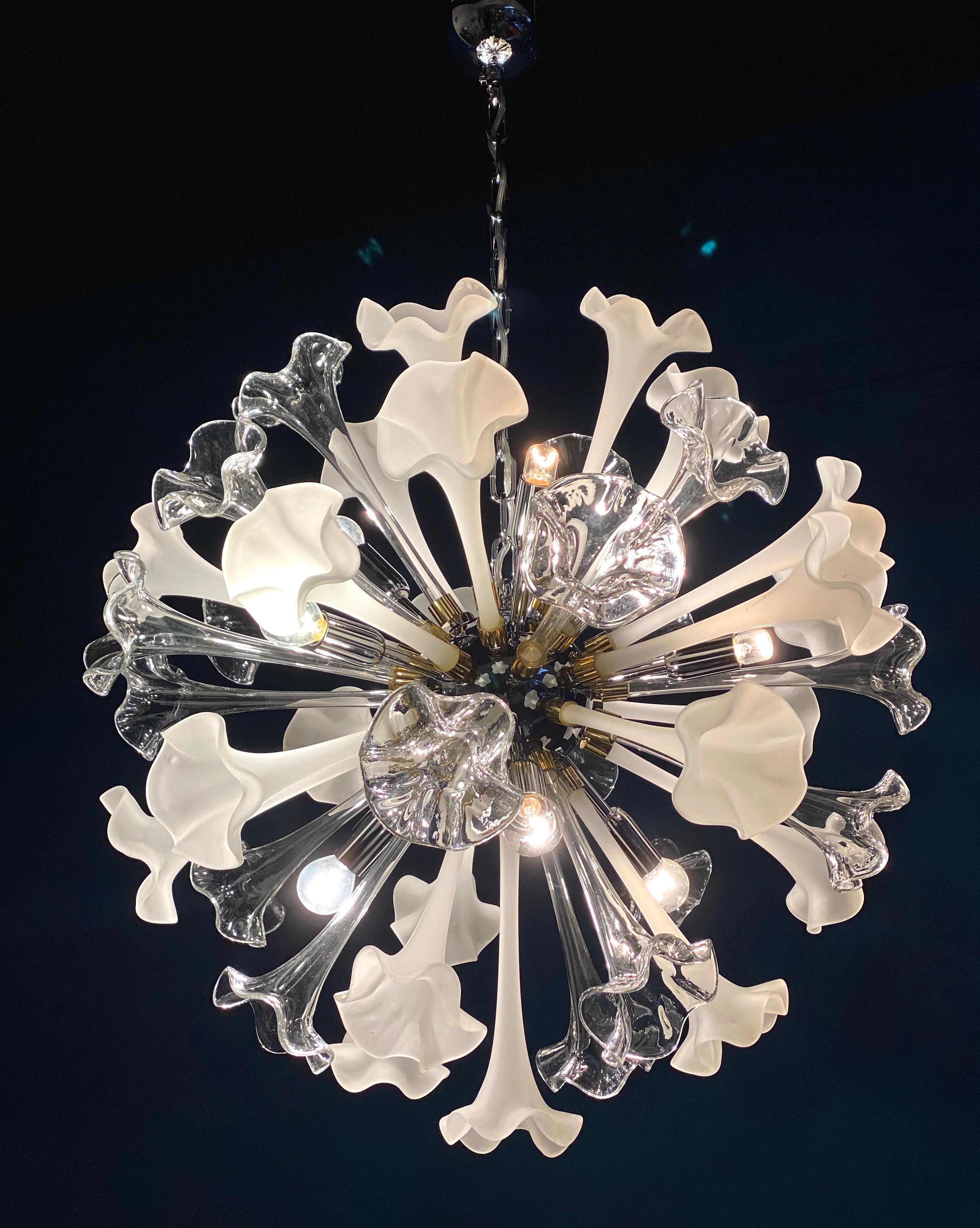Large contemporary Sputnik chandelier composed of precious hand blown Murano flowers art glasses with clear and white color. 
 Available also a pair.
Chromed steel spherical frame, with 10 E 14 \ 4 W light bulbs.
Measures: diameter cm 70, height