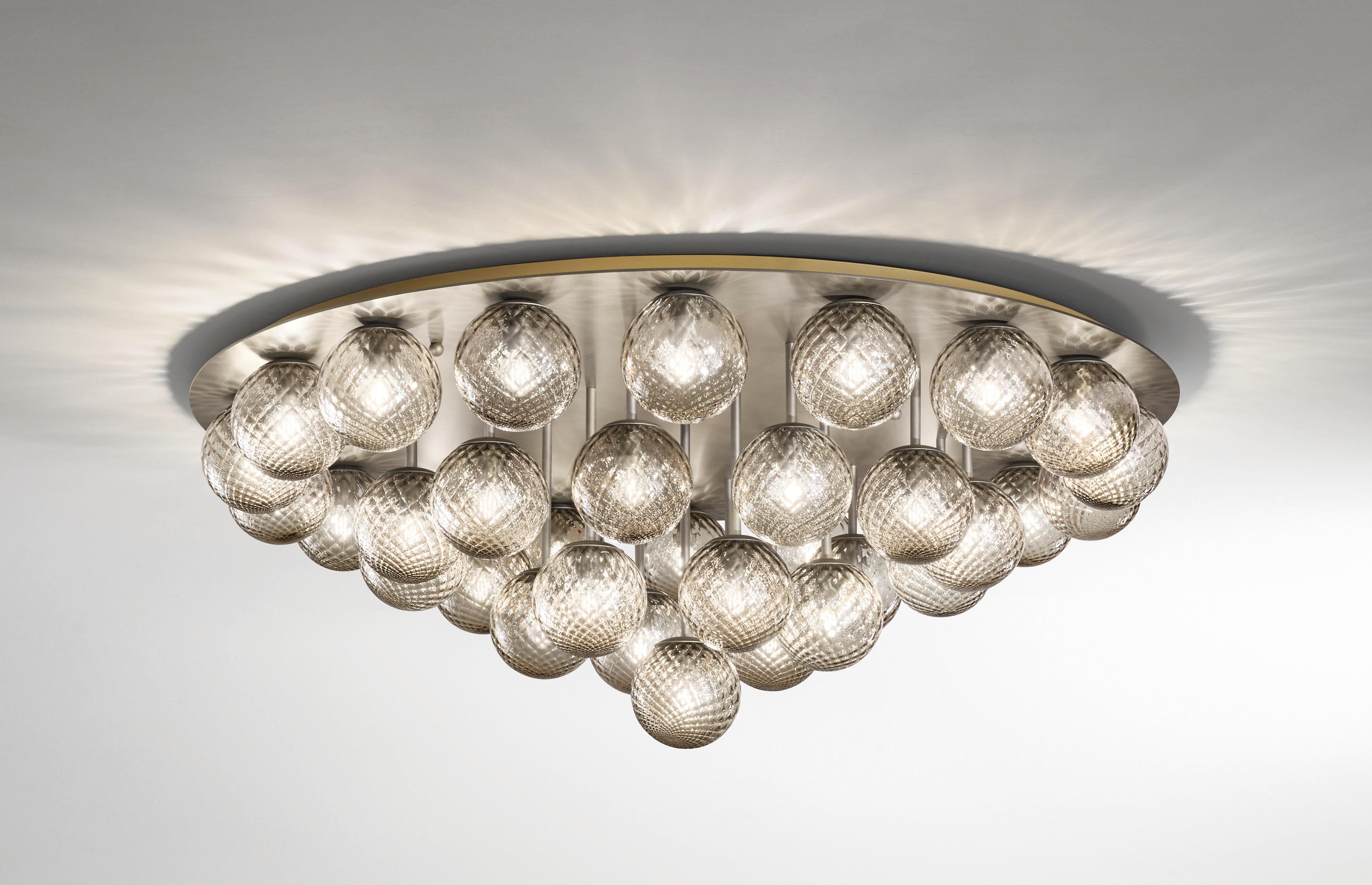 Italian modern flush mount with clear or smoky textured Murano glass globes, mounted on round ceiling plate in satin bronzato finish / Made in Italy by Fabio Ltd
37 lights / E12 or E14 type / max 40W each
Measures: diameter 52 inches, height 20