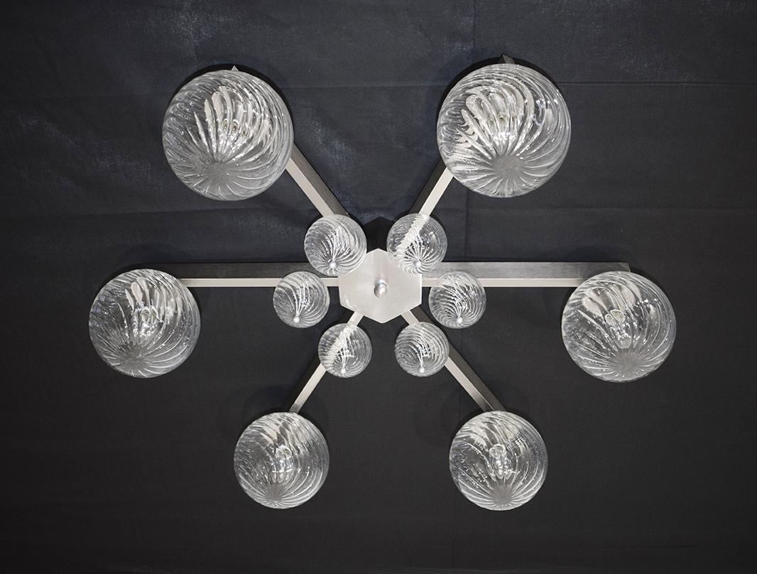 Italian modern flushmount with clear glass globes with twisted texture on satin nickel finish metal frame, designed by Fabio Bergomi for Fabio Ltd / Made in Italy
6 lights / E12 or E14 type / max 40W each
Measures: Diameter 31 inches / height 9.5