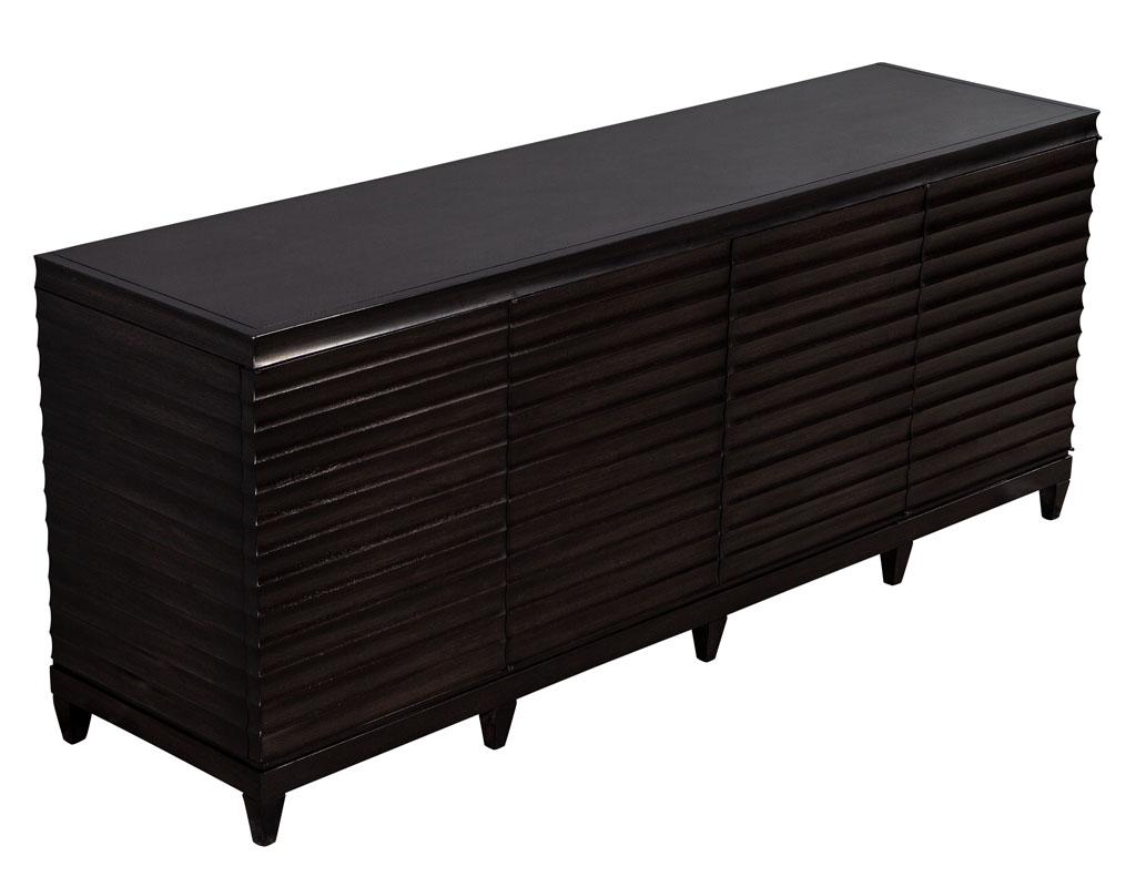 Modern Fluted buffet sideboard cabinet by Barbara Barry for Baker Furniture. Designed by Barbara Barry, this solid wood credenza is finished in a dark espresso walnut color. Featuring push latch fluted doors containing 2 large compartments and 5