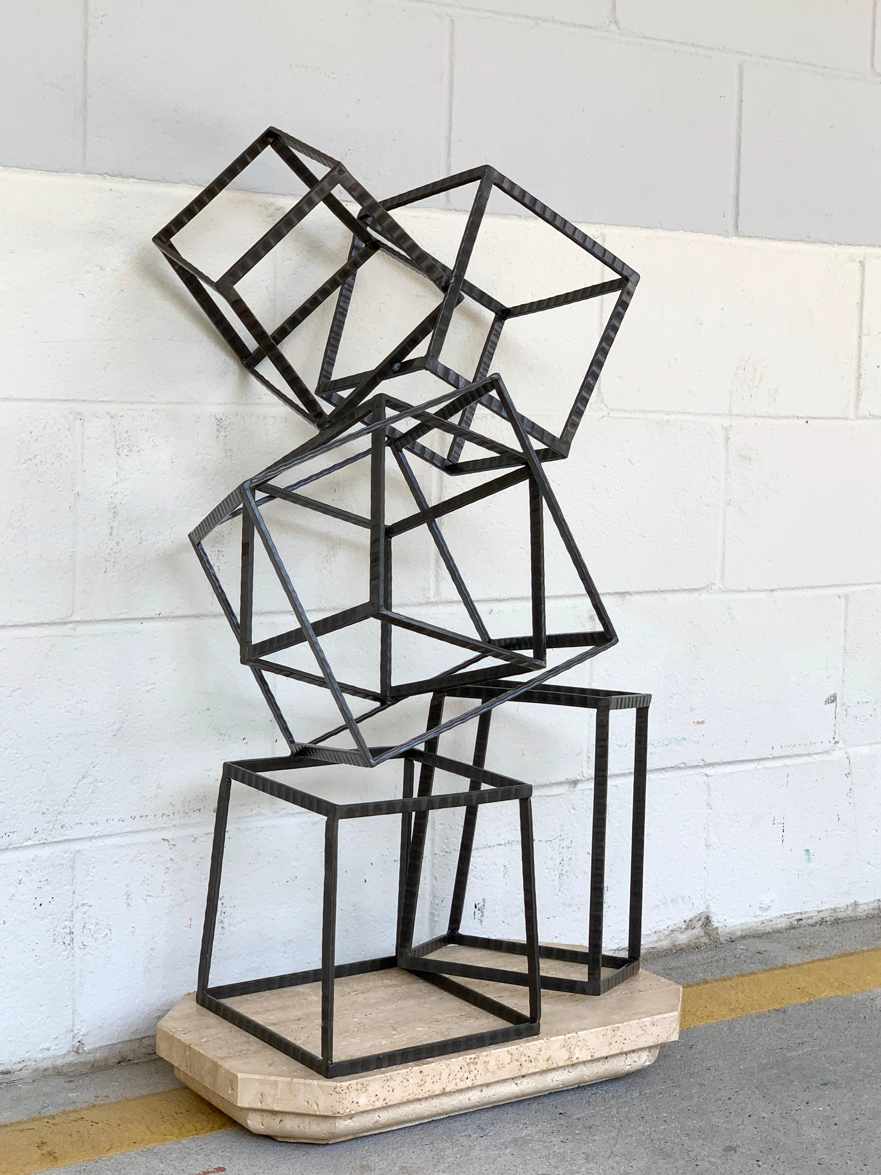 Modern forged iron and travertine quadrilaterals sculpture, with six balancing cubes of varying geometric shapes, raised on a conforming travertine base.
Measures: Sculpture alone 14