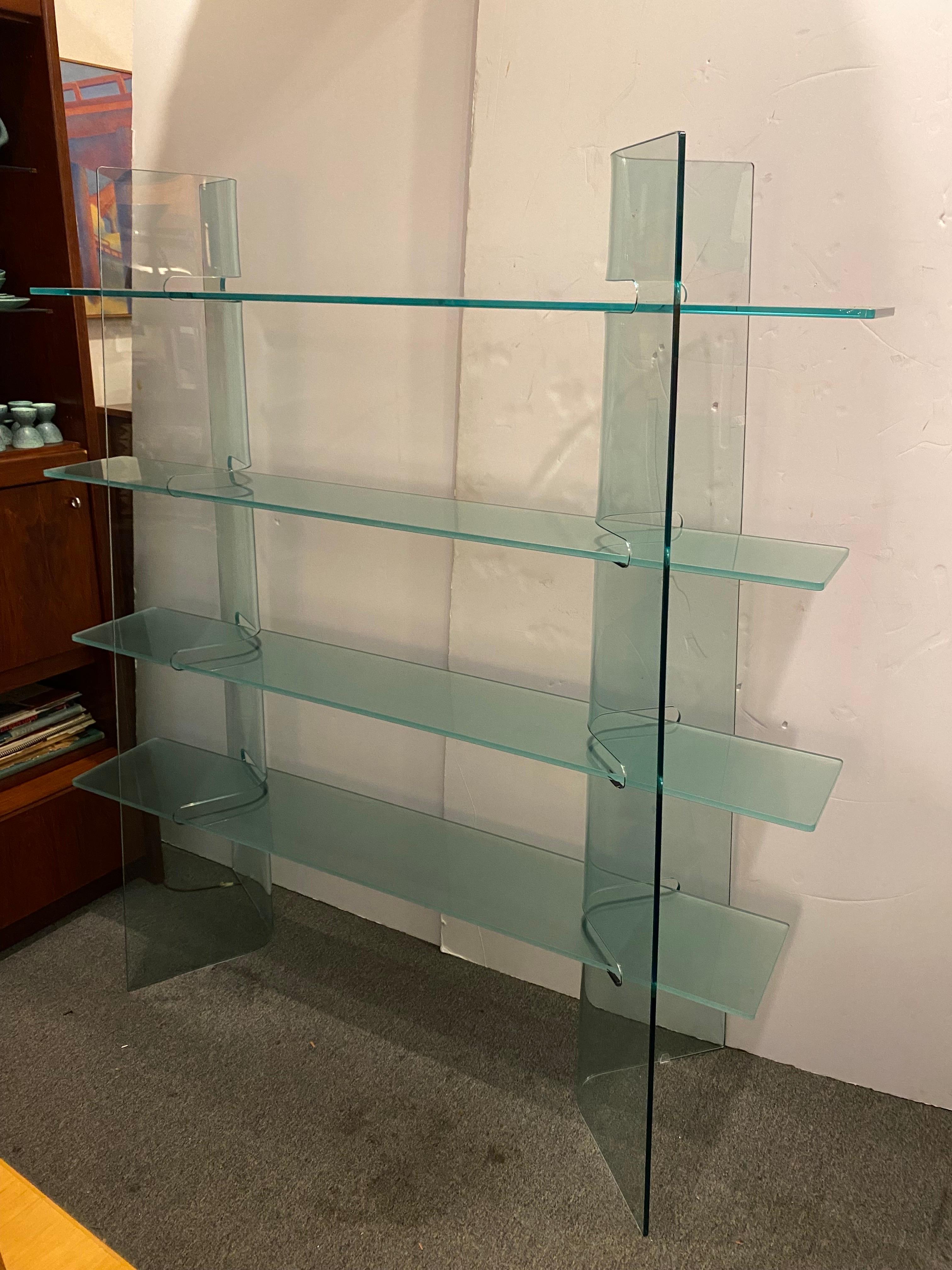Tempered Glass Shelf.  4 glass shelves fit into the curved column cut-outs.  Very solid design that sits very well!  Columns can be adjusted a bit as to where they sit.  2 Lower shelves slightly deeper.
