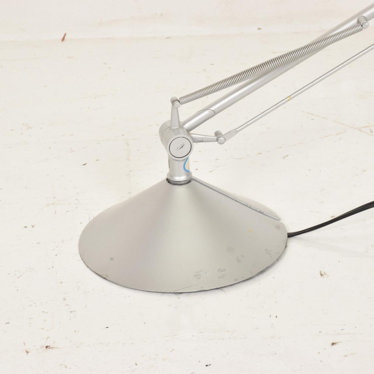 French Archimoon modern adjustable table lamp by noted French designer Philippe Starck for FLOS USA created by Philippe Starck in 2004 smart innovative modern design providing diffused and direct light, it has a fully articulated silver aluminum arm