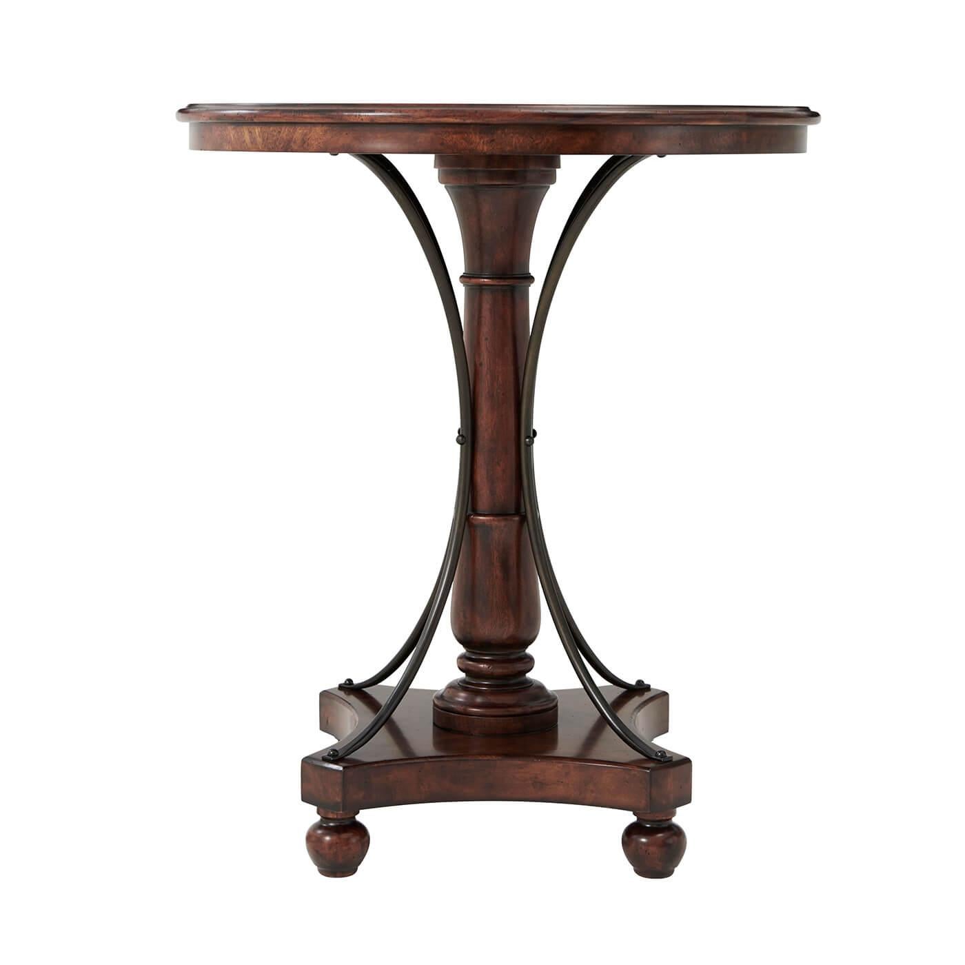 A French-style mahogany bar table, the circular crossbanded molded edge top above a ring turned column support with inswept brass stretchers, on a quatrefoil base raised on bun feet.

Dimensions: 36