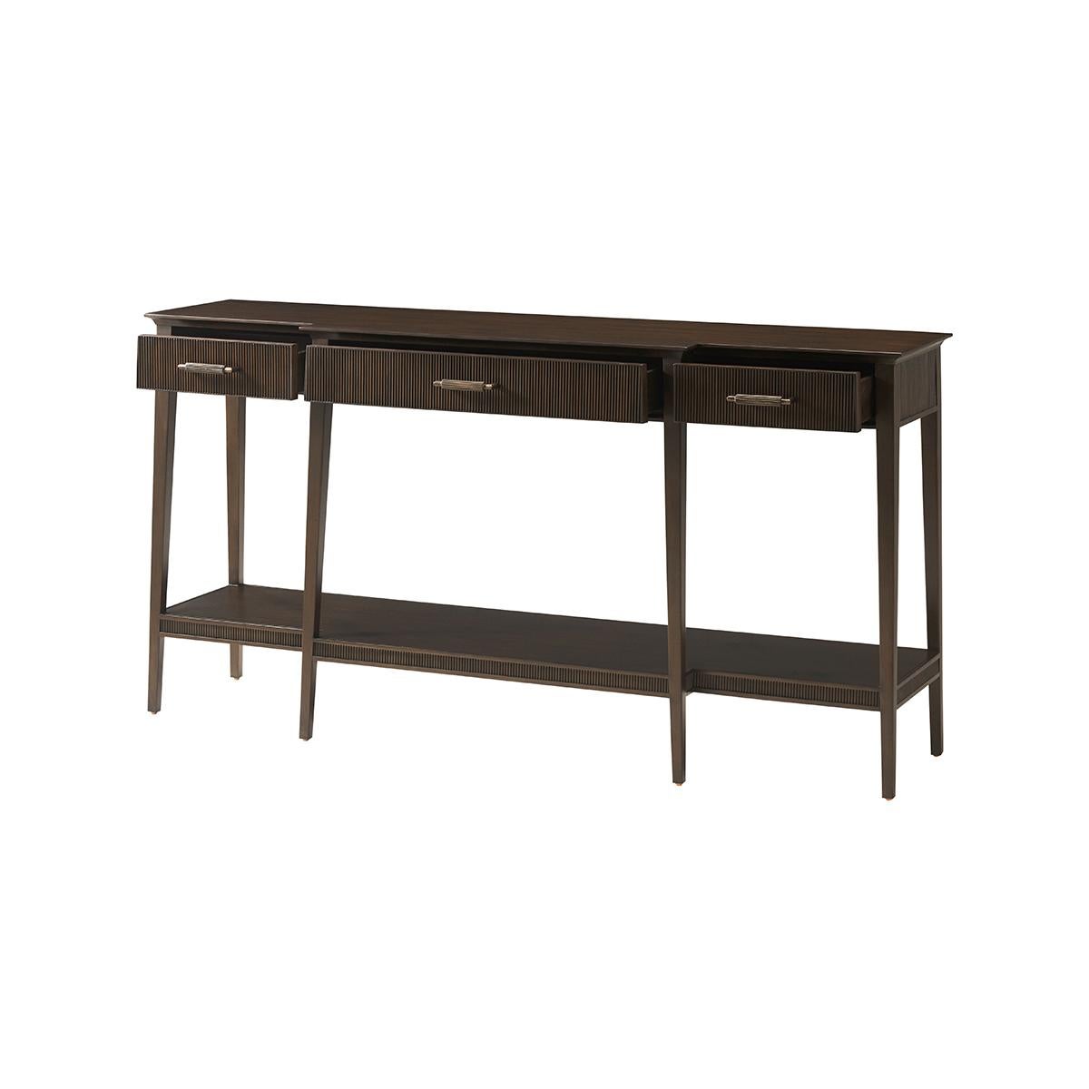 crafted from Prima Vera in our Bistre finish, and features an elegantly tapered silhouette, reeded detailing, three drawers and a shelf. The custom forged hardware, finished in a dark rubbed bronze, echoes the reeded details throughout.

Dimensions: