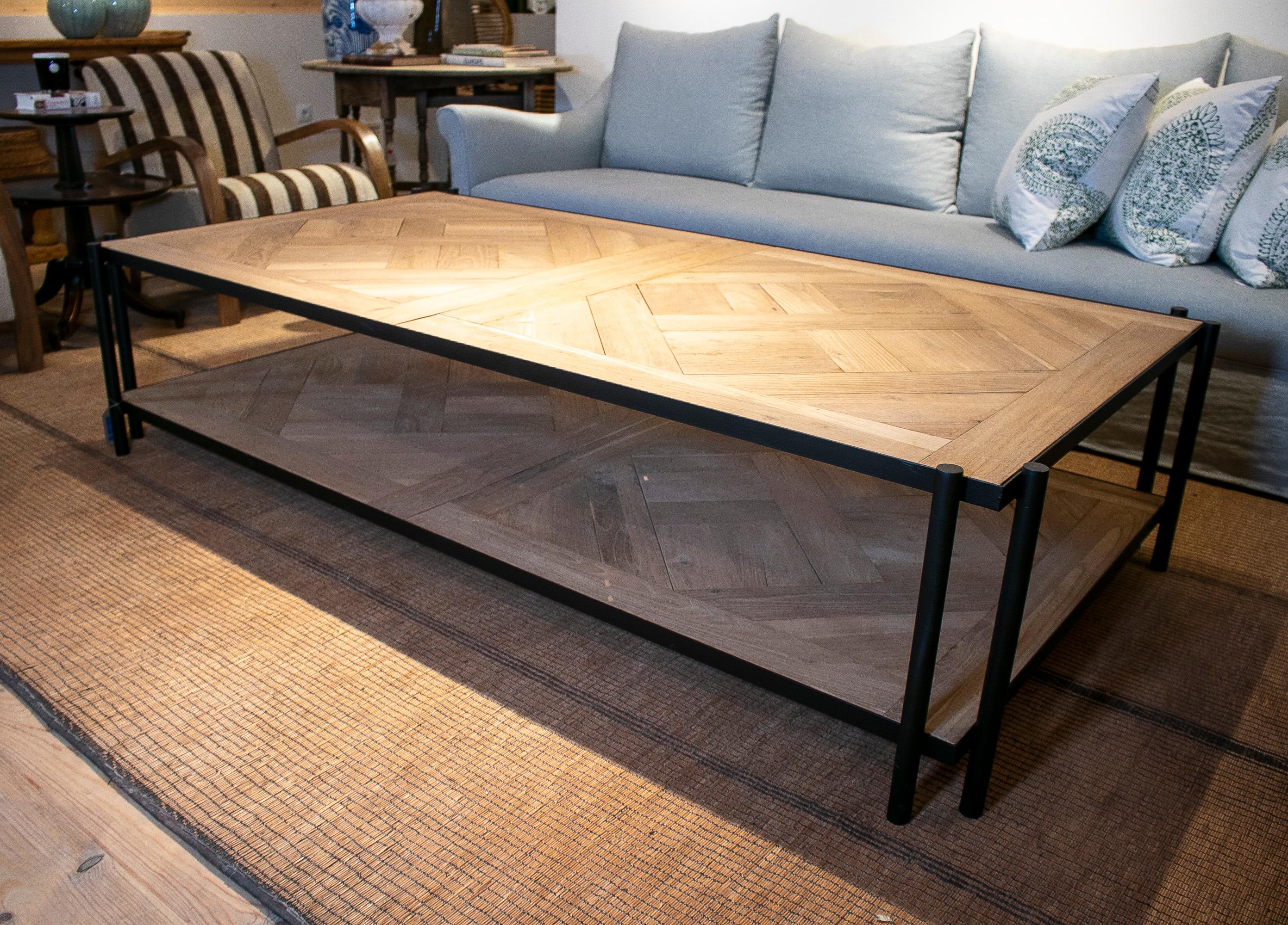 Modern French iron coffee table with classical Versailles parquet wood top and shelf. 
 