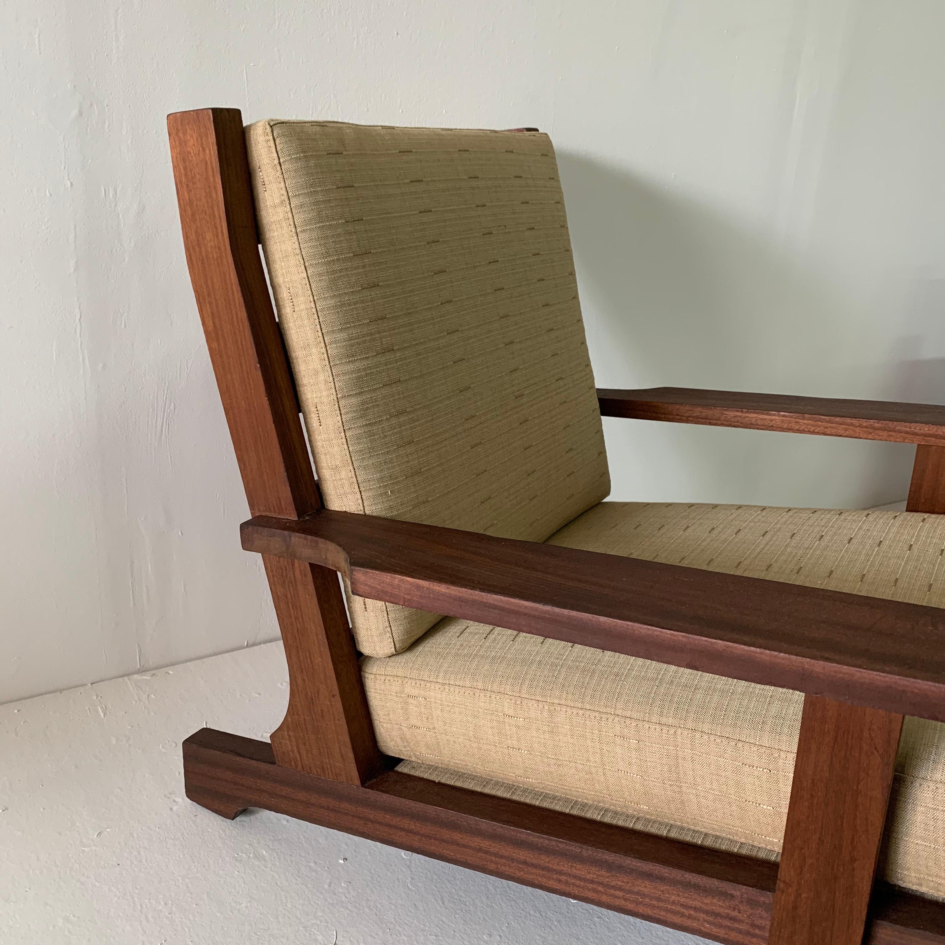 This is a wide, deep and low all teak armchair from France, made in 1960s. Finished with a beach-vibe fabric in neutral tones. This was acquired from the Estate of Amy Perlin, New York. There is a second similar style chair with a lower back