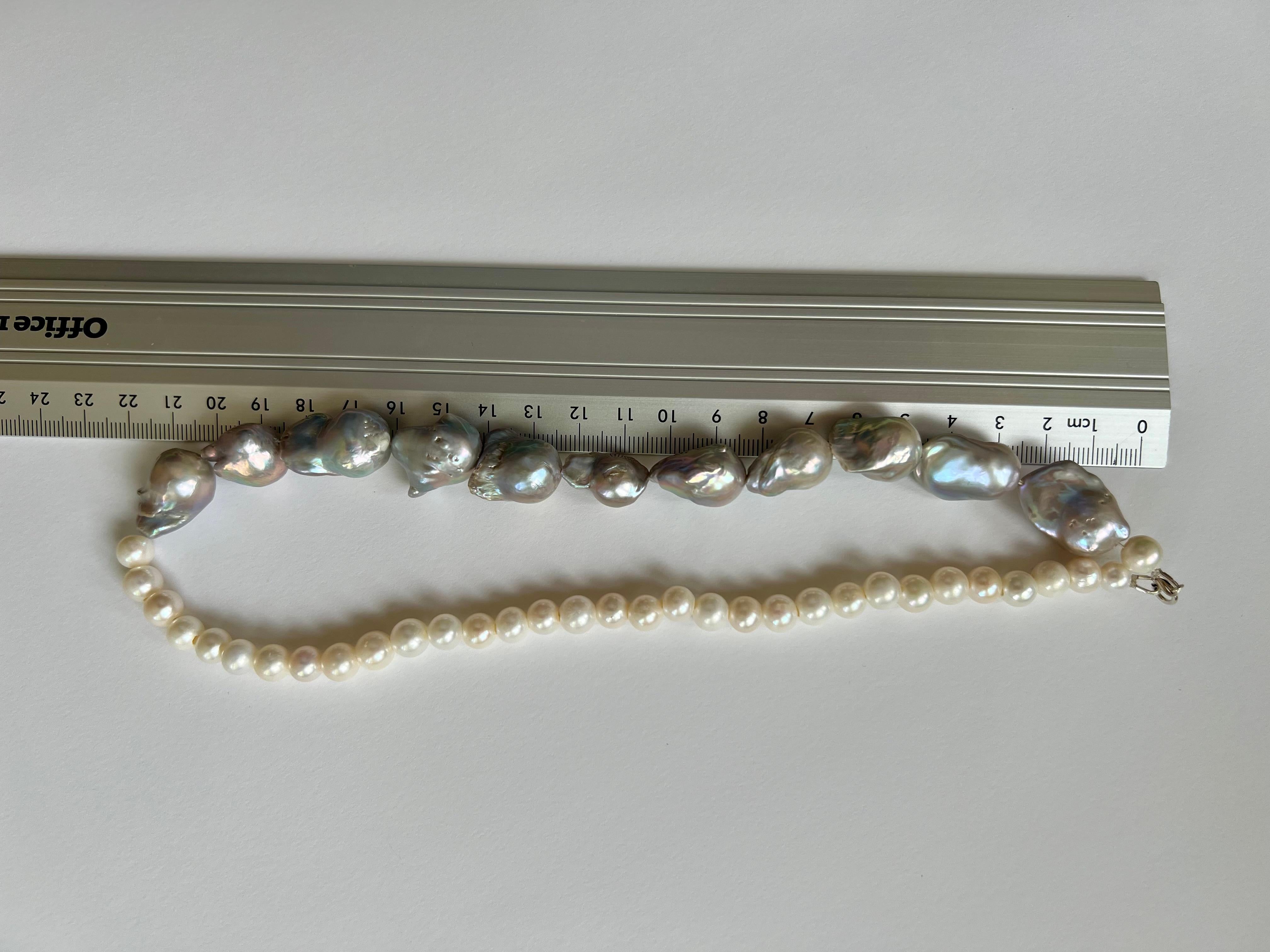 A beautiful and very modern way to wear pearls. this necklace is made of two different types of freshwater pearls. 
Grey baroque pearls with an average diameter of 12mm - 14mm and cream white freshwater pearls with an 8mm diameter.
The closure is