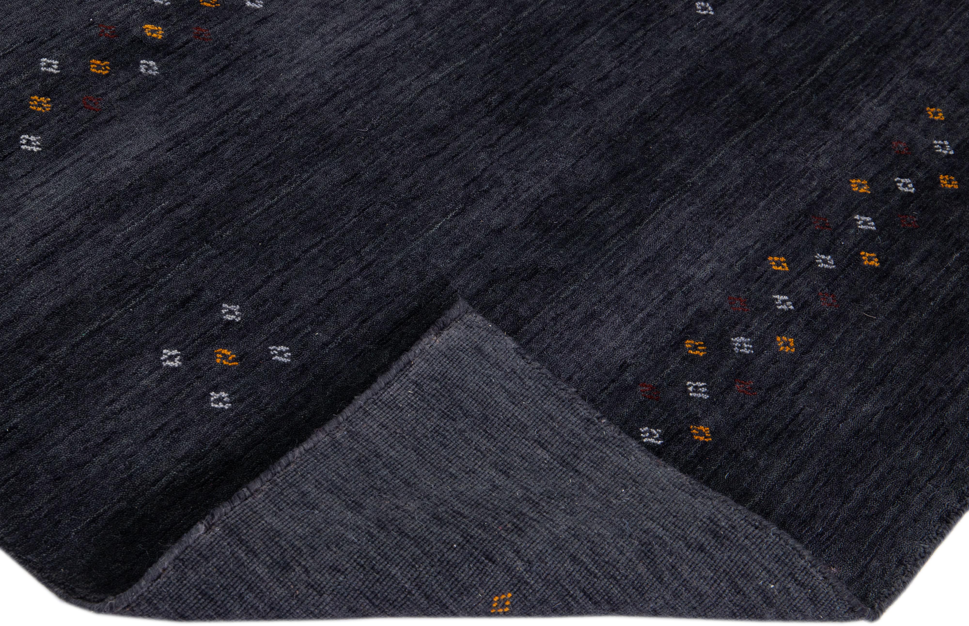 Beautiful modern Gabbeh style hand-knotted wool rug with a gray- charcoal field with gorgeous minimalist design.

This rug measures: 4'3