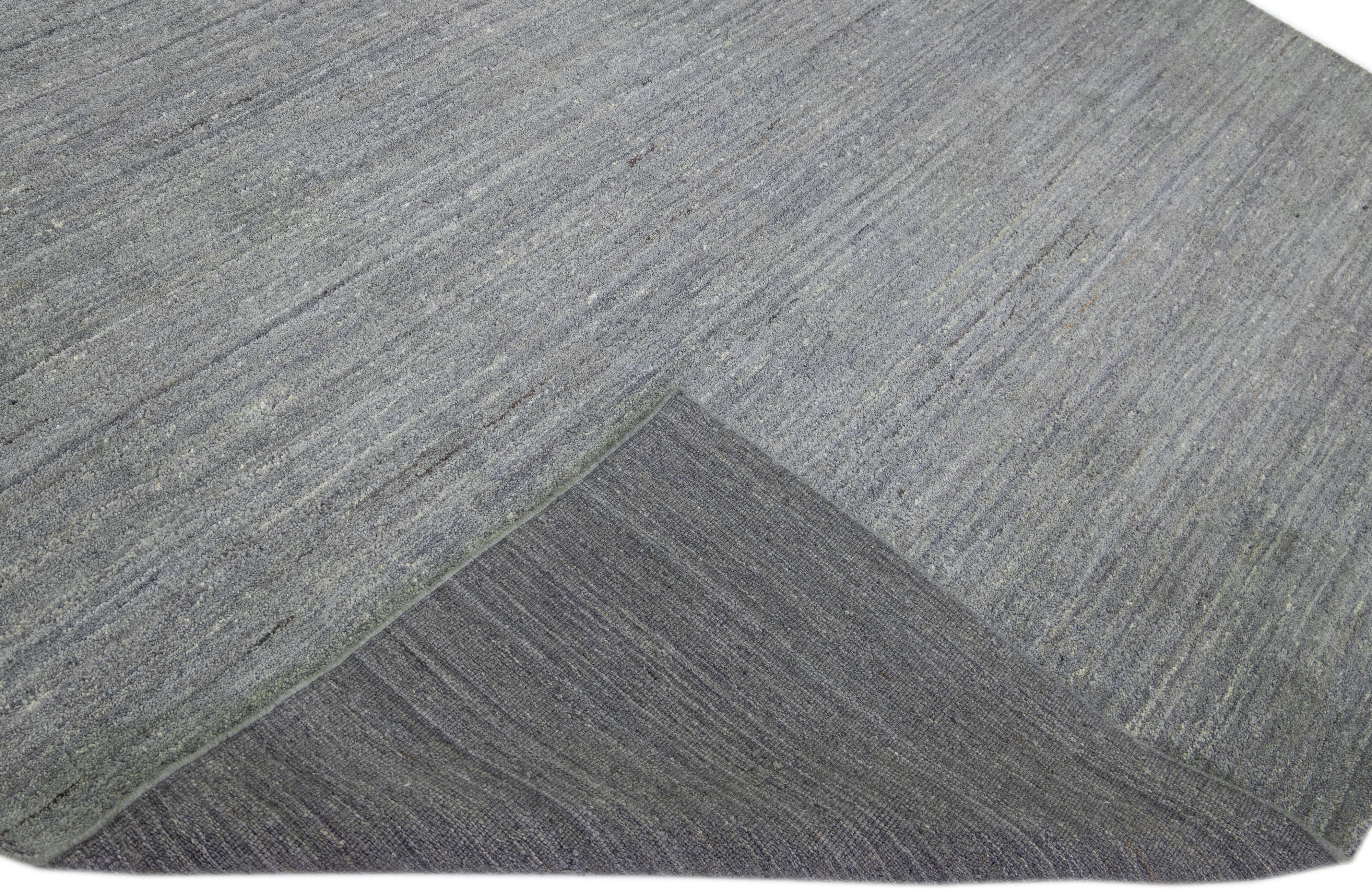 Beautiful modern Gabbeh style hand-knotted wool rug with a gray field in a gorgeous solid design.

This rug measures: 8'9
