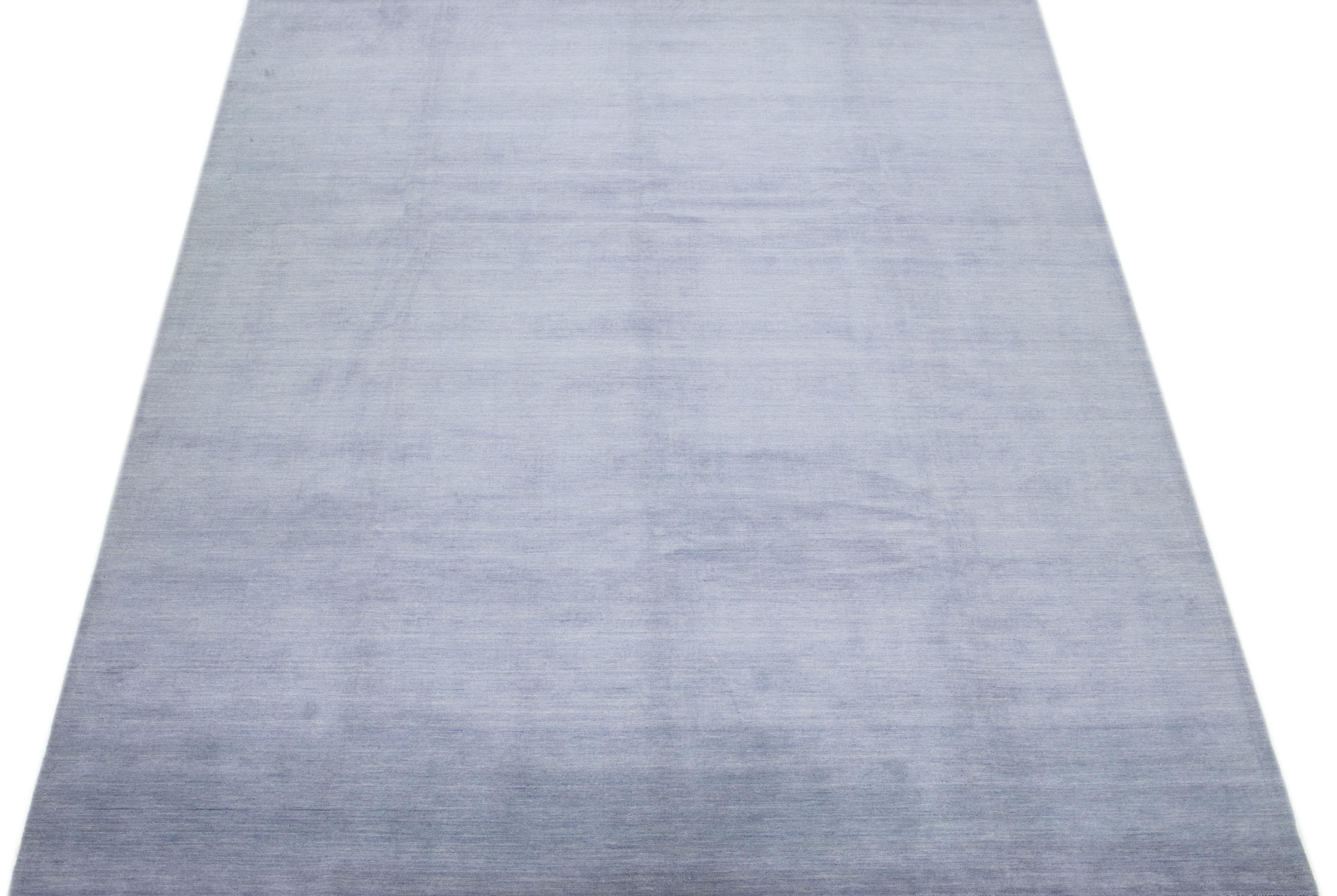 The contemporary appeal of this woolen rug, in the style of Gabbeh, lies in its Solid gray color field. The hand-woven piece is sure to catch the eye with its modern design.

This rug measures 9' x 12'4