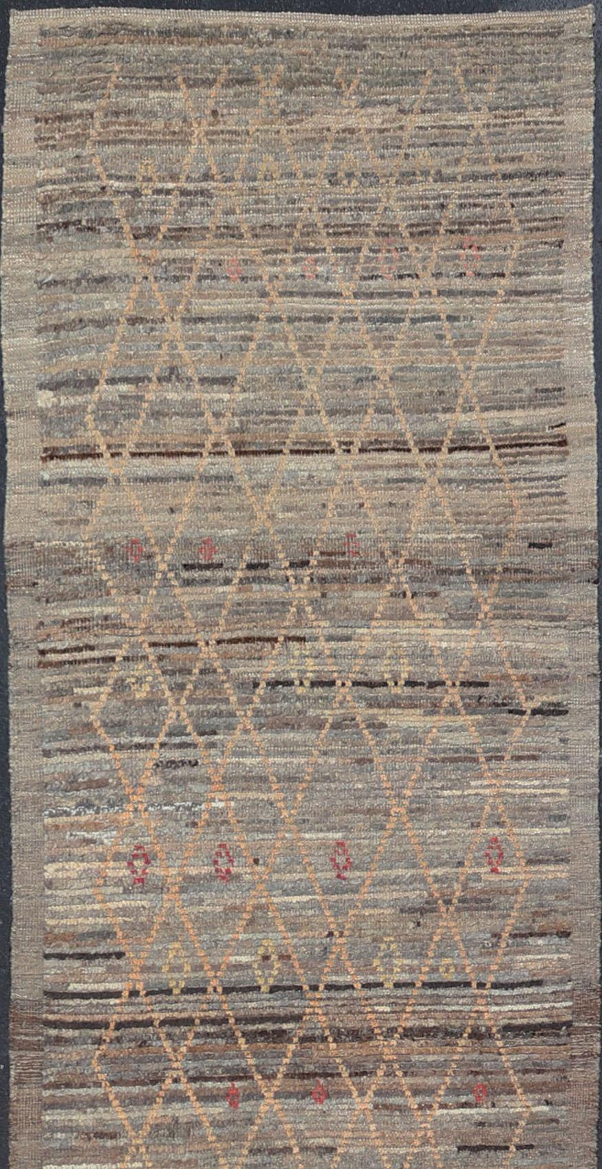 Gray background with gold and red highlights in tribal design and free-flowing Moroccan design, Keivan Woven Arts / rug AFG-36109, country of origin / type: Afghanistan / piled

The geometric design of this rug makes it great option for modern and