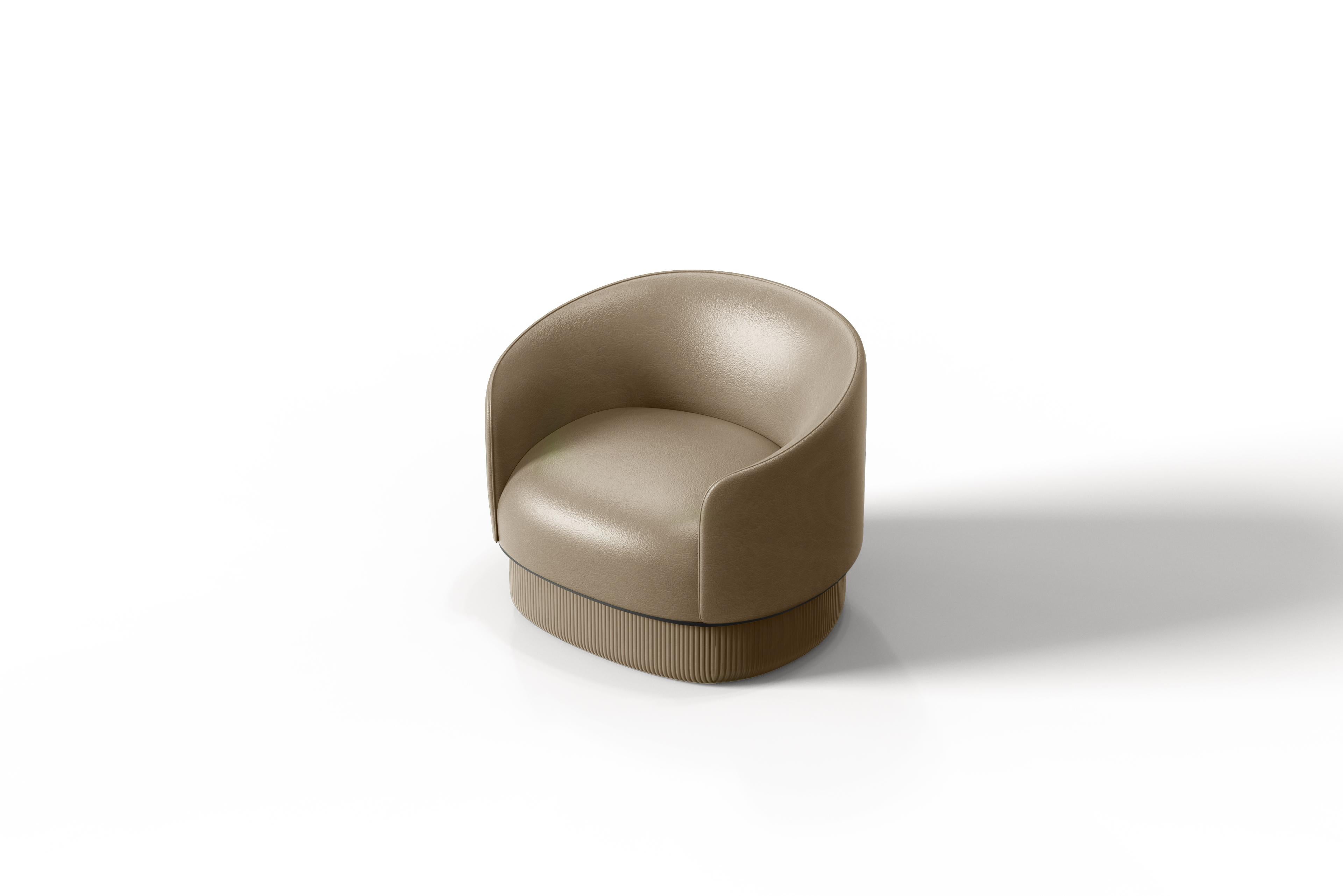 The Modern Gentle Armchair merges luxurious comfort with sophisticated design. Its smooth leather shell contrasts beautifully with a quilted leather base, where vertical stitching creates a rich 3D texture. A sleek metal ring elegantly divides these