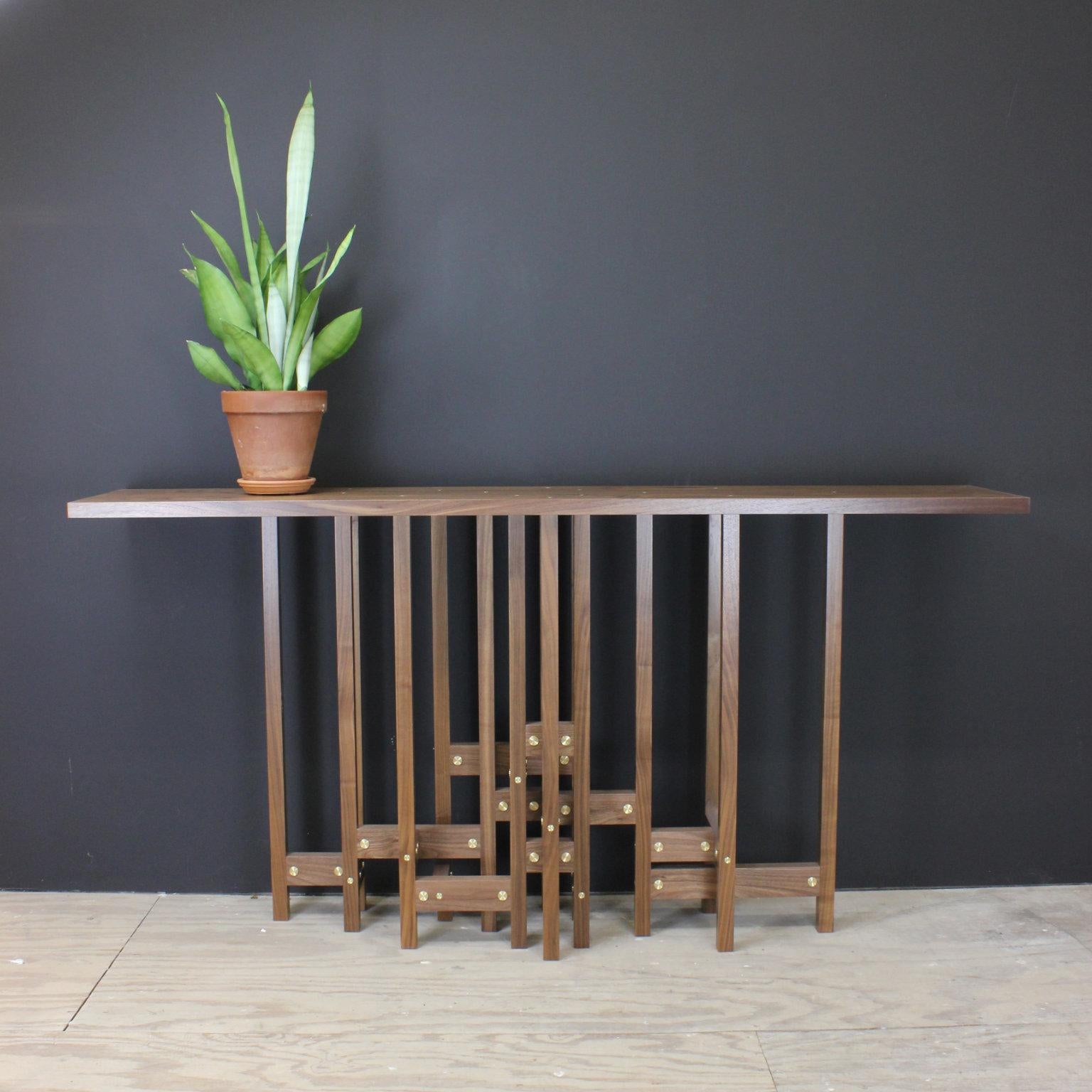 The Mneme hall table continues my exploration of visual complexity with an uncommon amount of verticals and horizontals to make a table base. Mneme features horizontal elements that are twice the width of the base grid. They are densest and highest