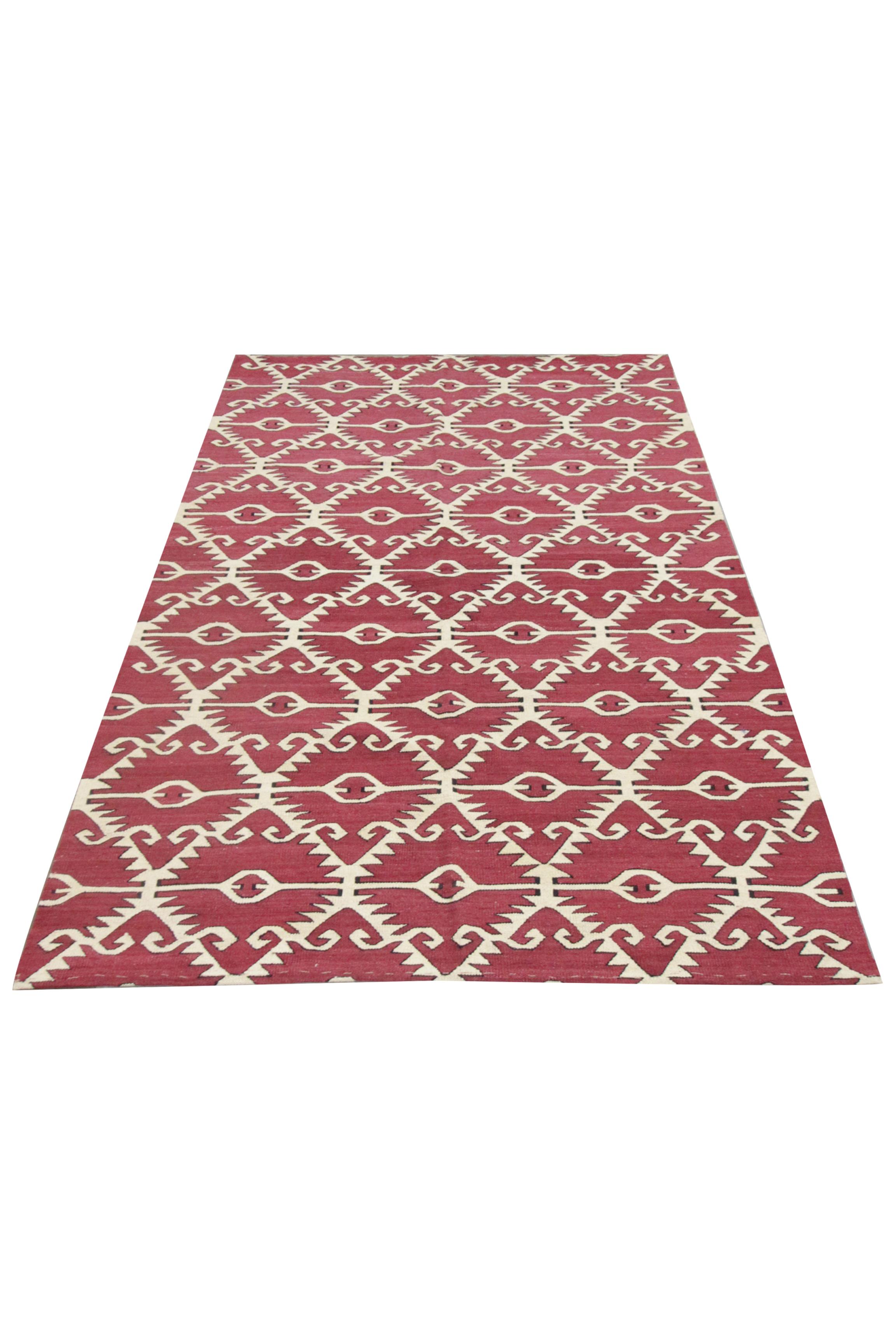 This fine wool area rug is a handwoven modern Kilim. The bold design has been woven with a simple colour palette of cream and red with gentle black accents. The pattern is an all-over repeating design with hooks and diamonds. 
Kilim rugs are woven