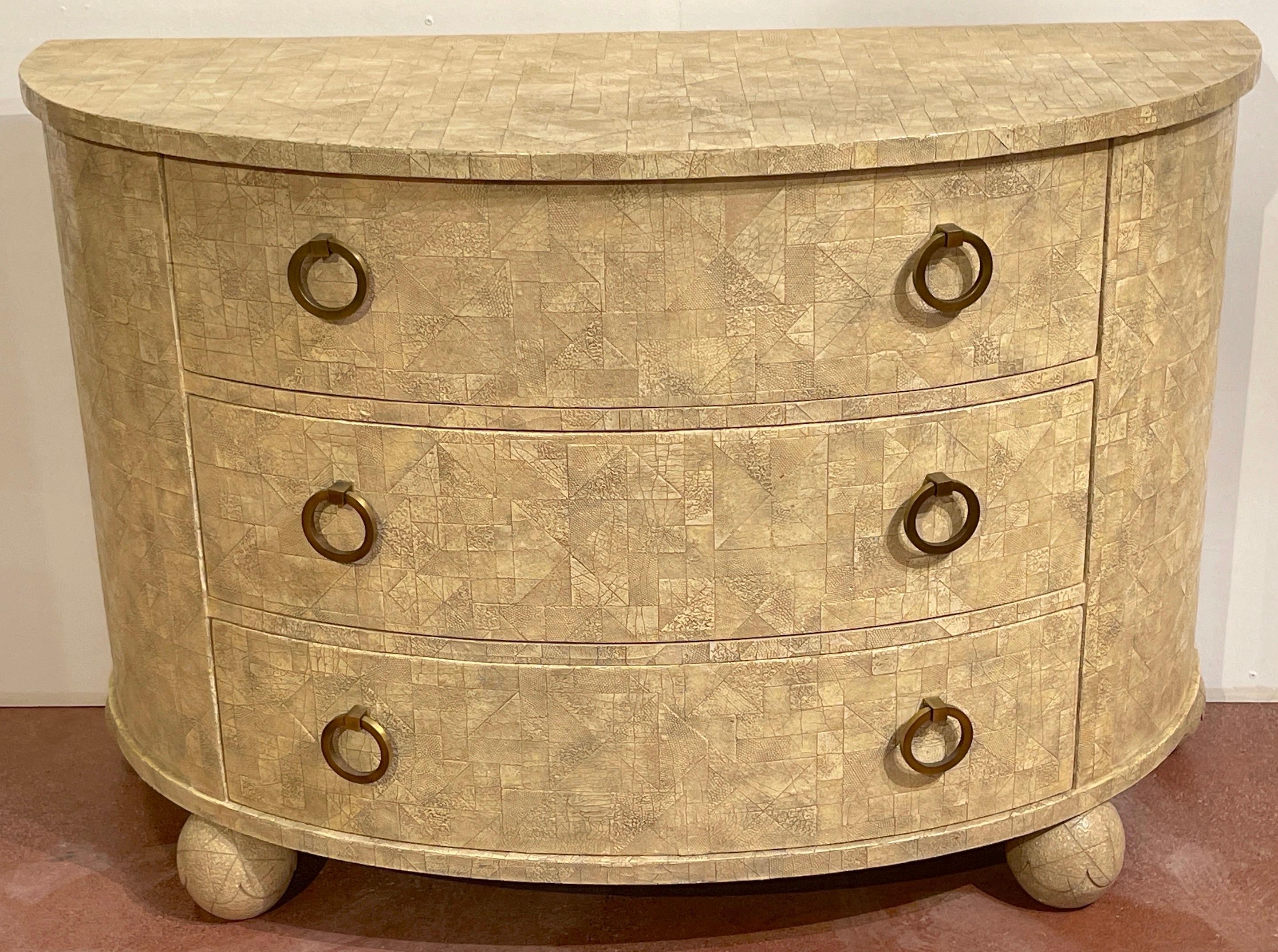 Modern Geometric leather Mosaic commode by Henredon 

A unique limited production chest, With all-over ,countless geometric leather mosaics inset on the demilune form. fitted with three- long drawers each with two large bronze ring handles, raised