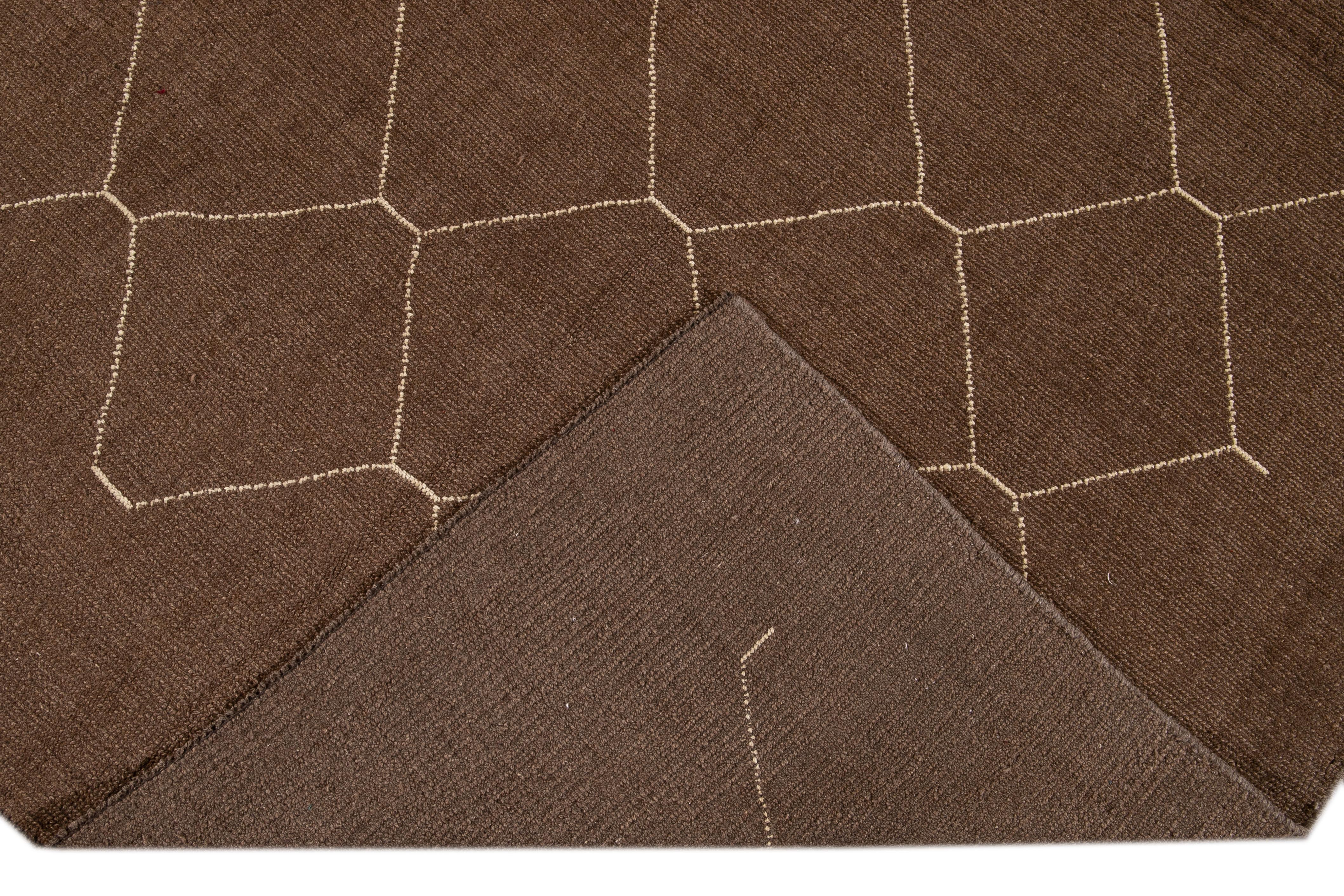 Beautiful contemporary Morrocan style hand-knotted wool rug with a brown field. This Moroccan rug has a beige accent in a gorgeous geometric Diamond pattern design.

This rug measures 7' x 10'.

  