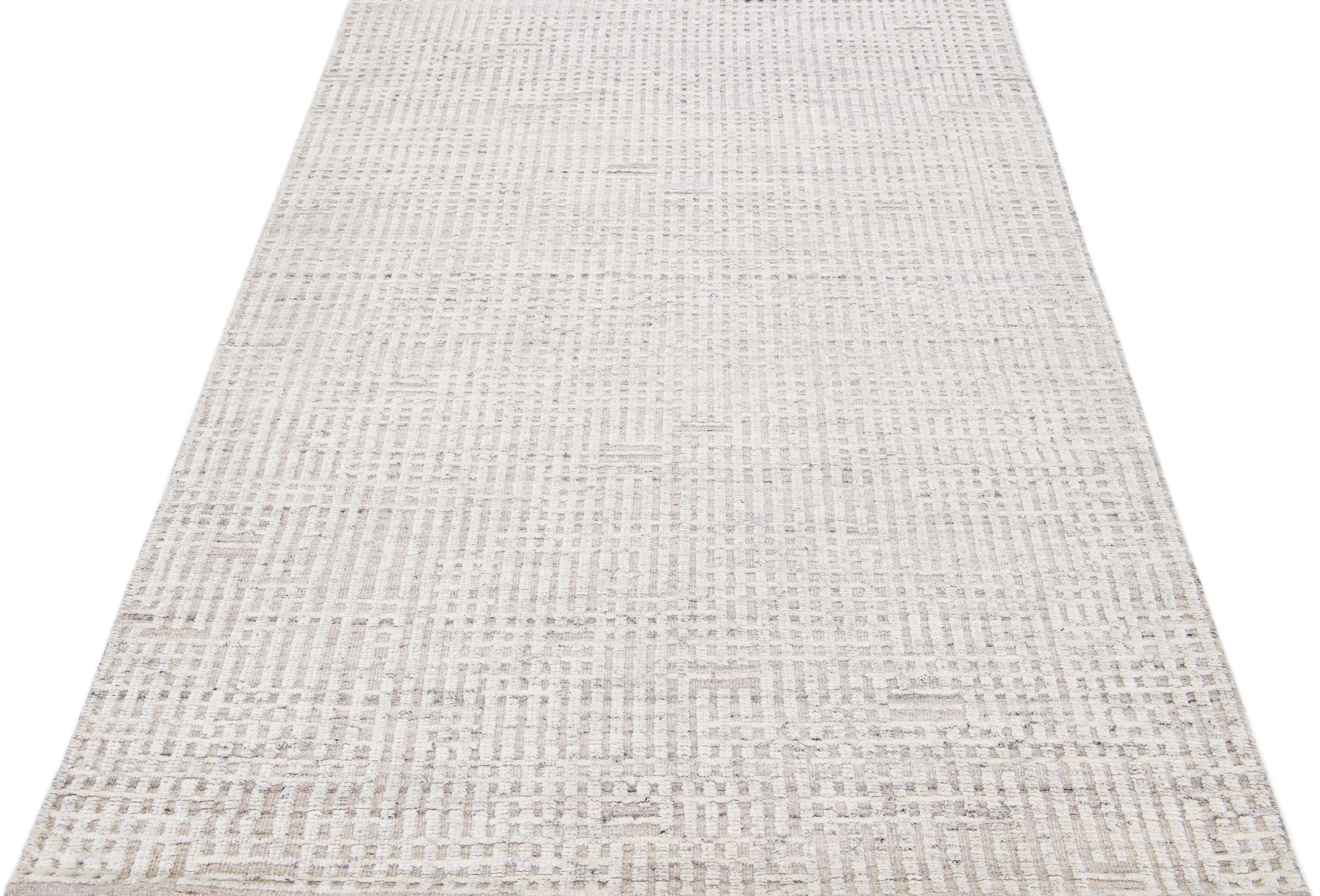 Beautiful modern Moroccan-style hand-knotted wool rug with a beige color field. This rug is part of our Apadana's Safi Collection and features a minimalist design in white and gray.

This rug measures: 5'2