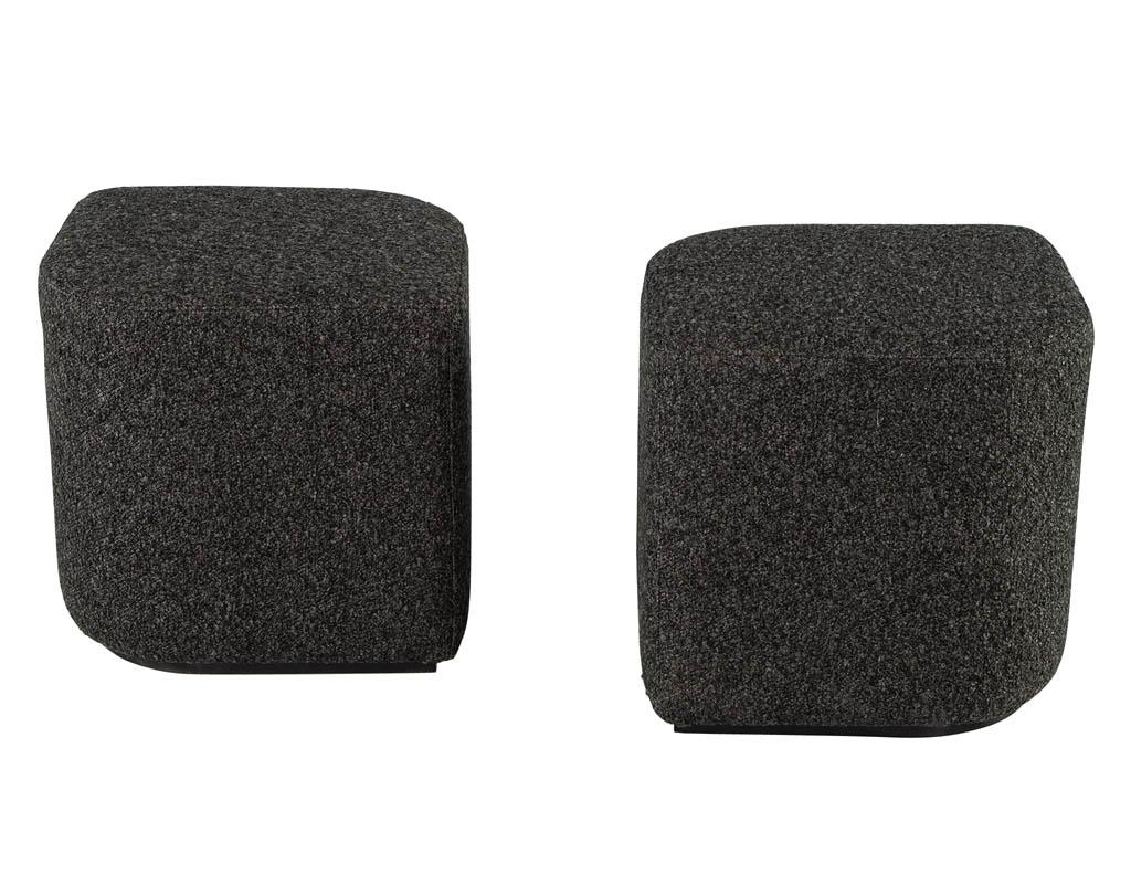 Modern Geometric Ottomans in Textured Fabric. Unique geometric shaping makes this modern ottoman stand out. Fully upholstered in a dense textured fabric with a mix of dark charcoal, grey and white color tones. Completed with a recessed black