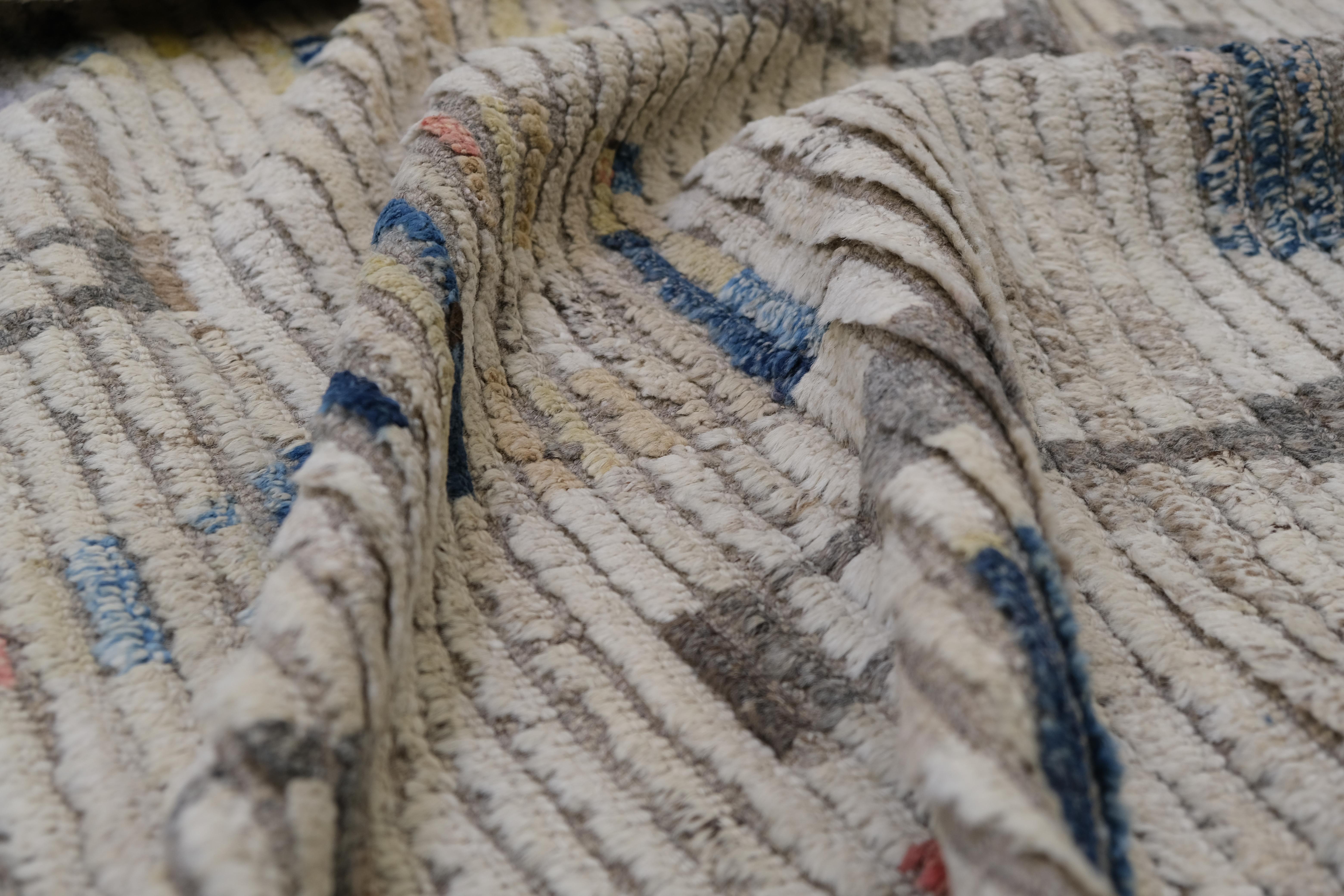 Entdecken Sie den Charme traditioneller Handwerkskunst, die in diesem handgeknüpften Wollteppich mit modernem Design verschmilzt. Mit einem atemberaubenden geometrischen Motiv, das an Stammeskunst erinnert, kombiniert dieses Stück erdige Töne mit