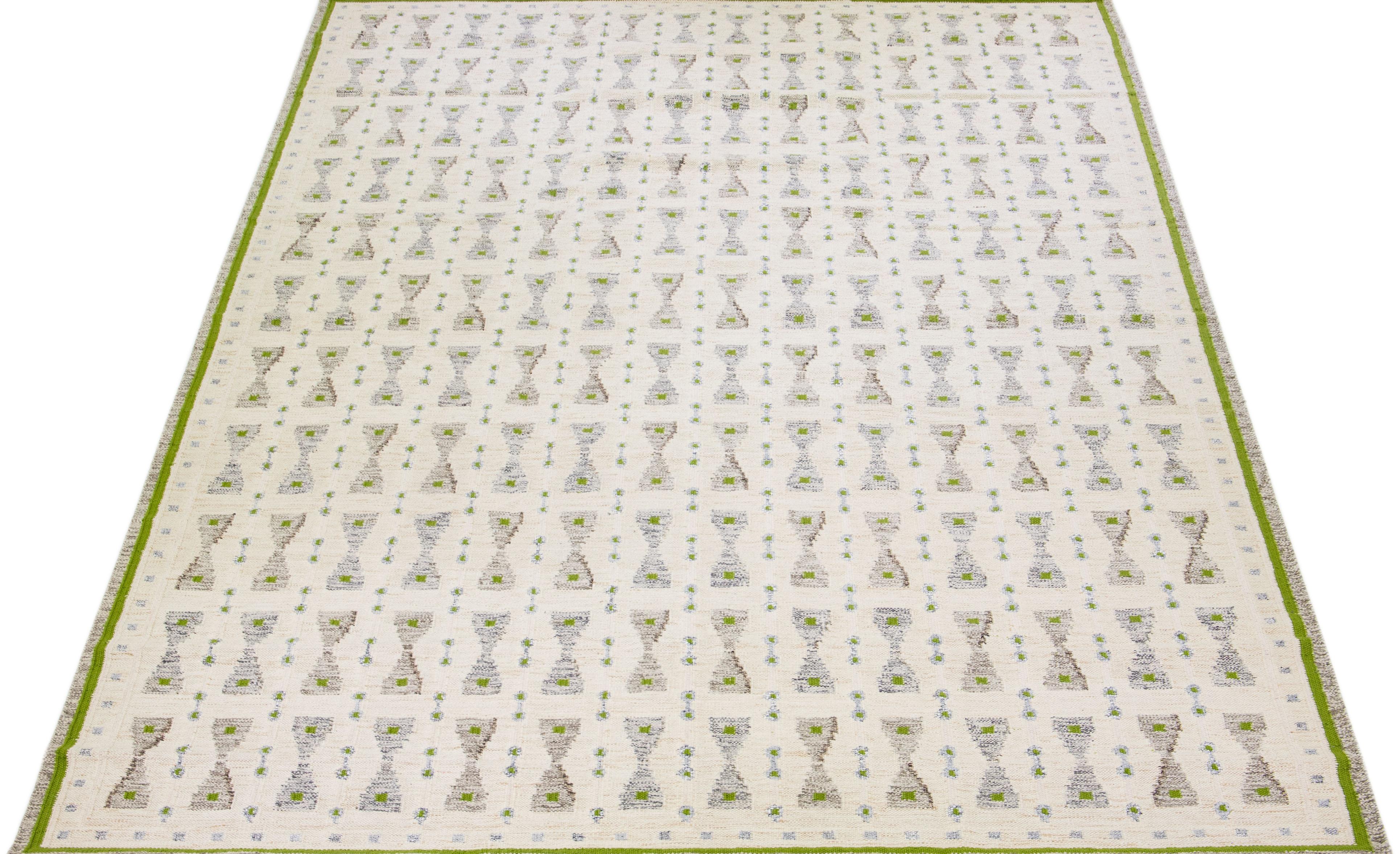Beautiful modern Swedish-style wool rug with a beige field. This Swedish rug has gray, brown, and green accent colors in a gorgeous, all-over geometric design.

 This rug measures: 8' x 10'.

Our rugs are professional cleaning before shipping.