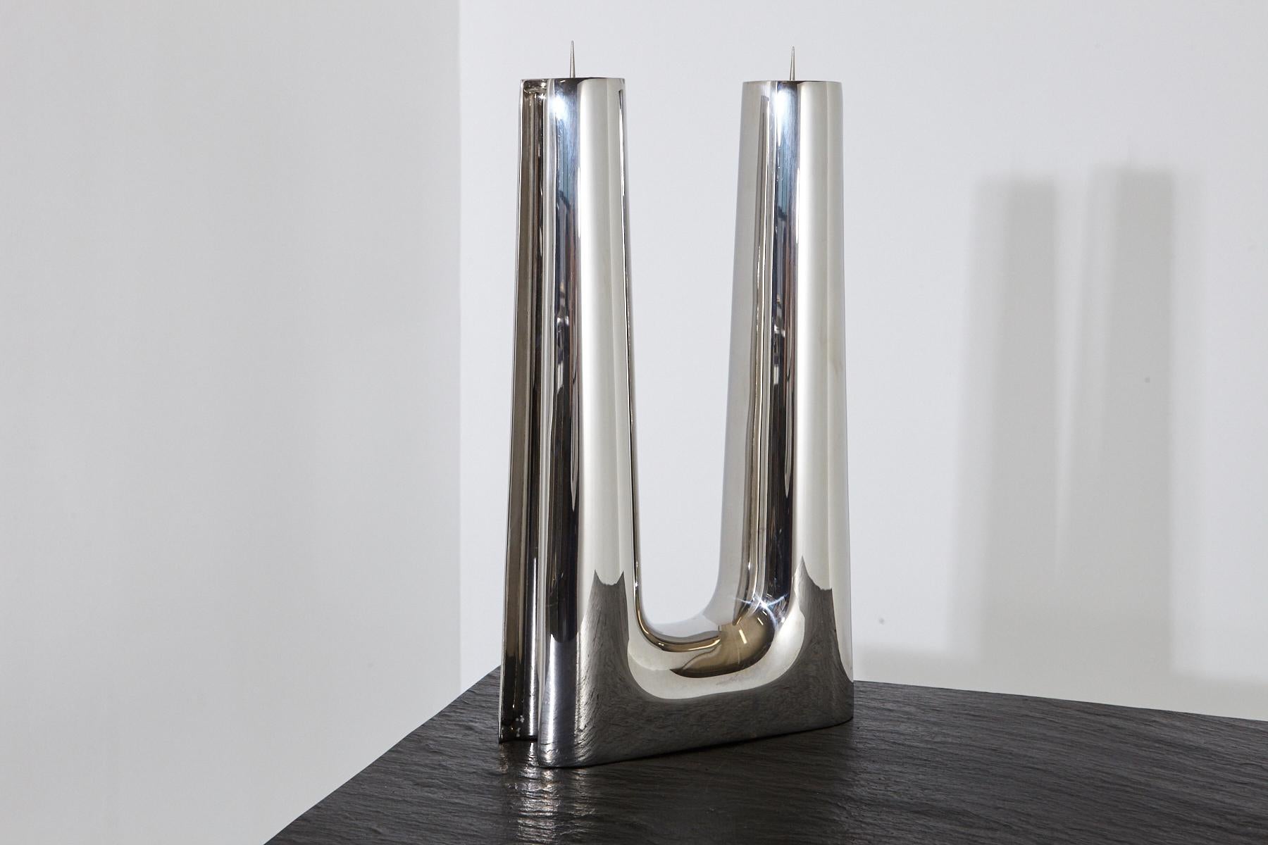 A modern, simple, Minimalist polished stainless steel candleholder by Georg Jensen for two candles. 
The candle holder has some minor scratches to the surface consistent to use.