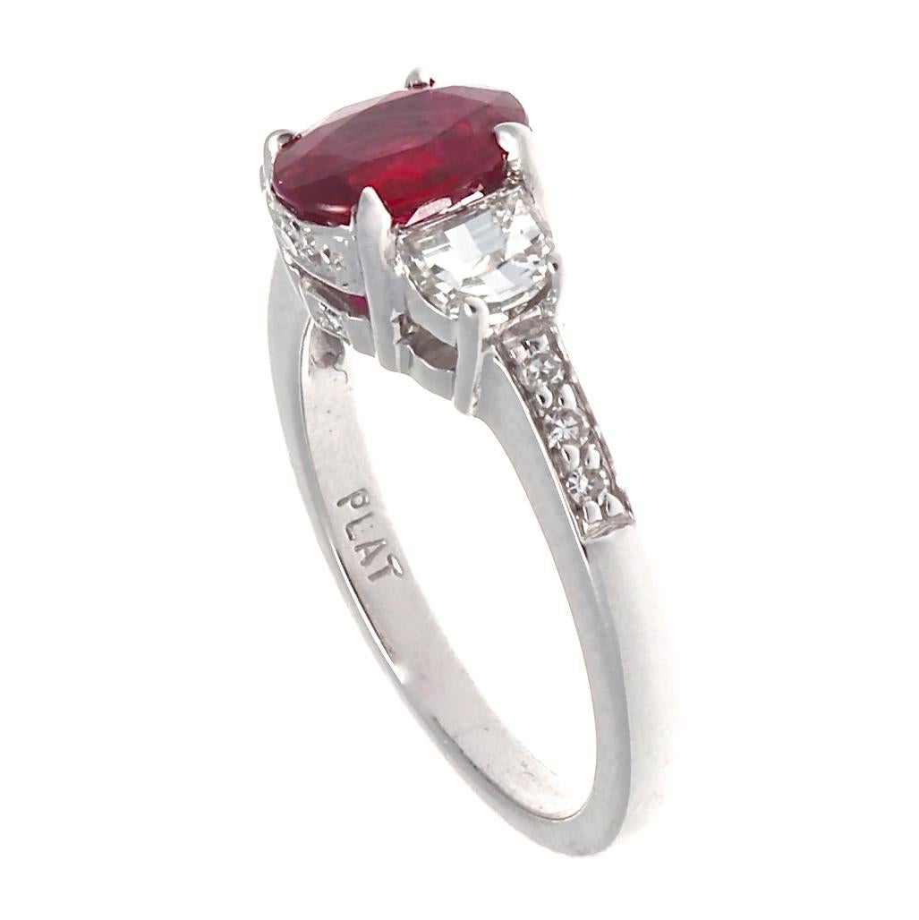 This pigeon's blood ruby is certified by GIA as of Burma origin. Its beautiful 1.57 carats are  accented by 2 gleaming half moon diamonds that weigh approximately 0.70 carats total and are graded H-I color, VS clarity. The sides of the shank are