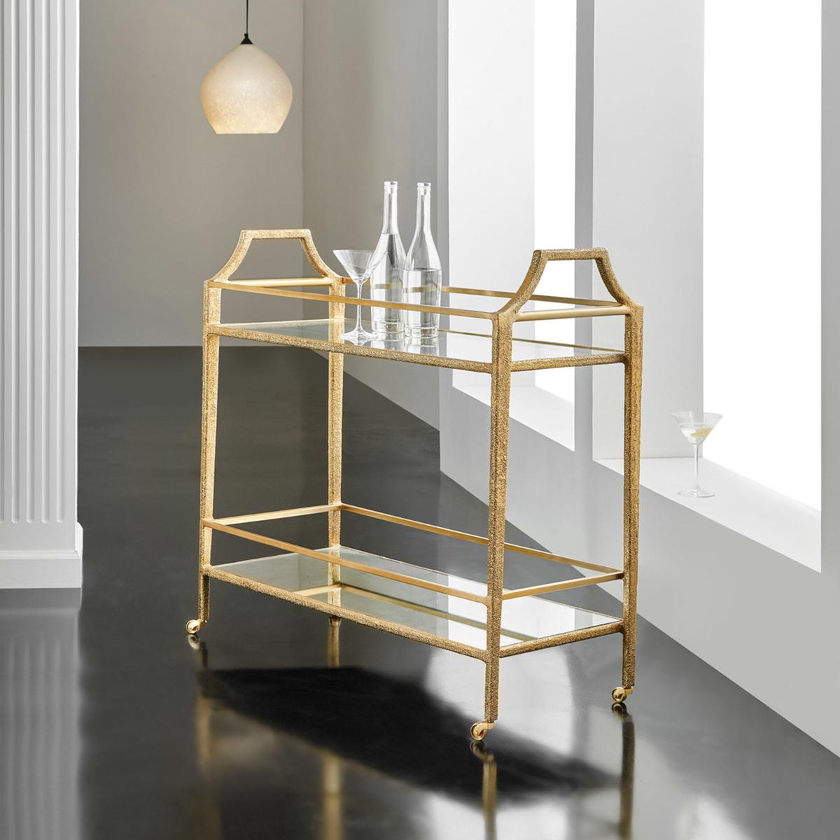 Modern Gilt Bar Cart with brass frame wrapped in textured gold with two shelves, tapered legs raised on brass casters. The texture appears to be like pointillism art.

Dimensions: 37.5