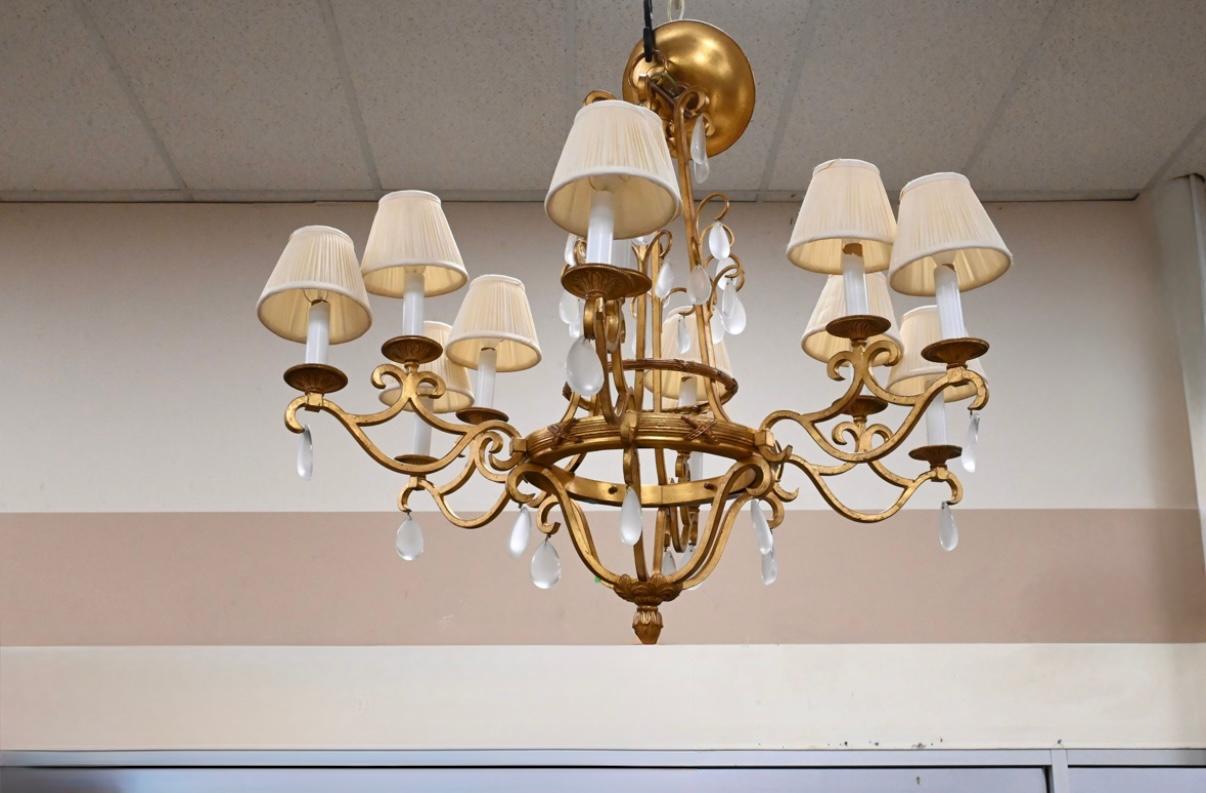 This elegant 12-light chandelier is a stunning example of modern design, blending timeless opulence with contemporary refinement. Crafted in gilt bronze, the chandelier radiates warmth and sophistication, its golden framework serving as the perfect