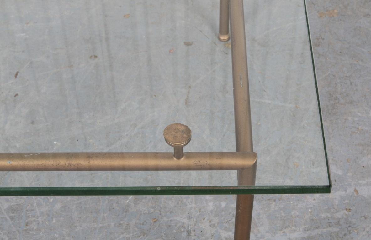 Modern gilt metal and glass table 15” H x 24.5” W x 24.5” D.