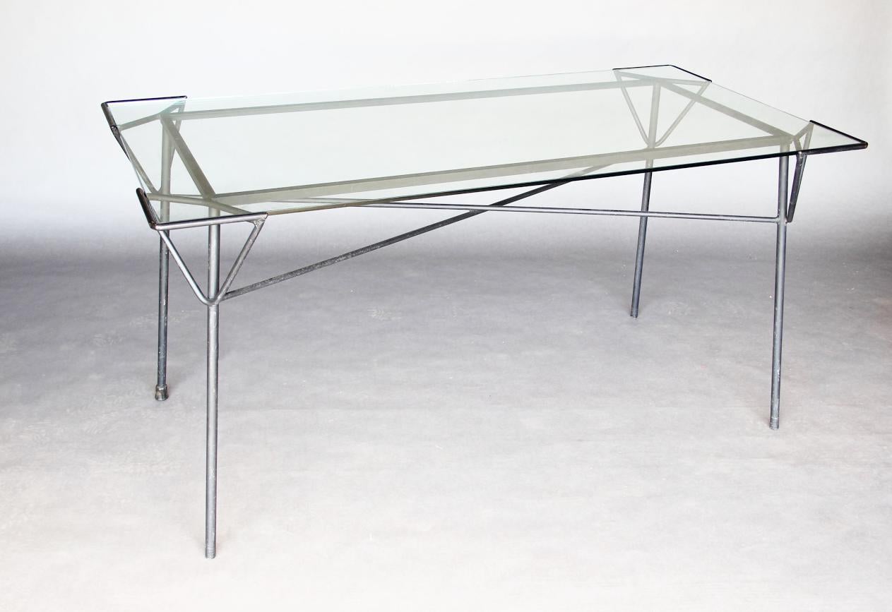 Subtle design of iron base accentuates the look of glass top a good size. Straight Angular lines.
