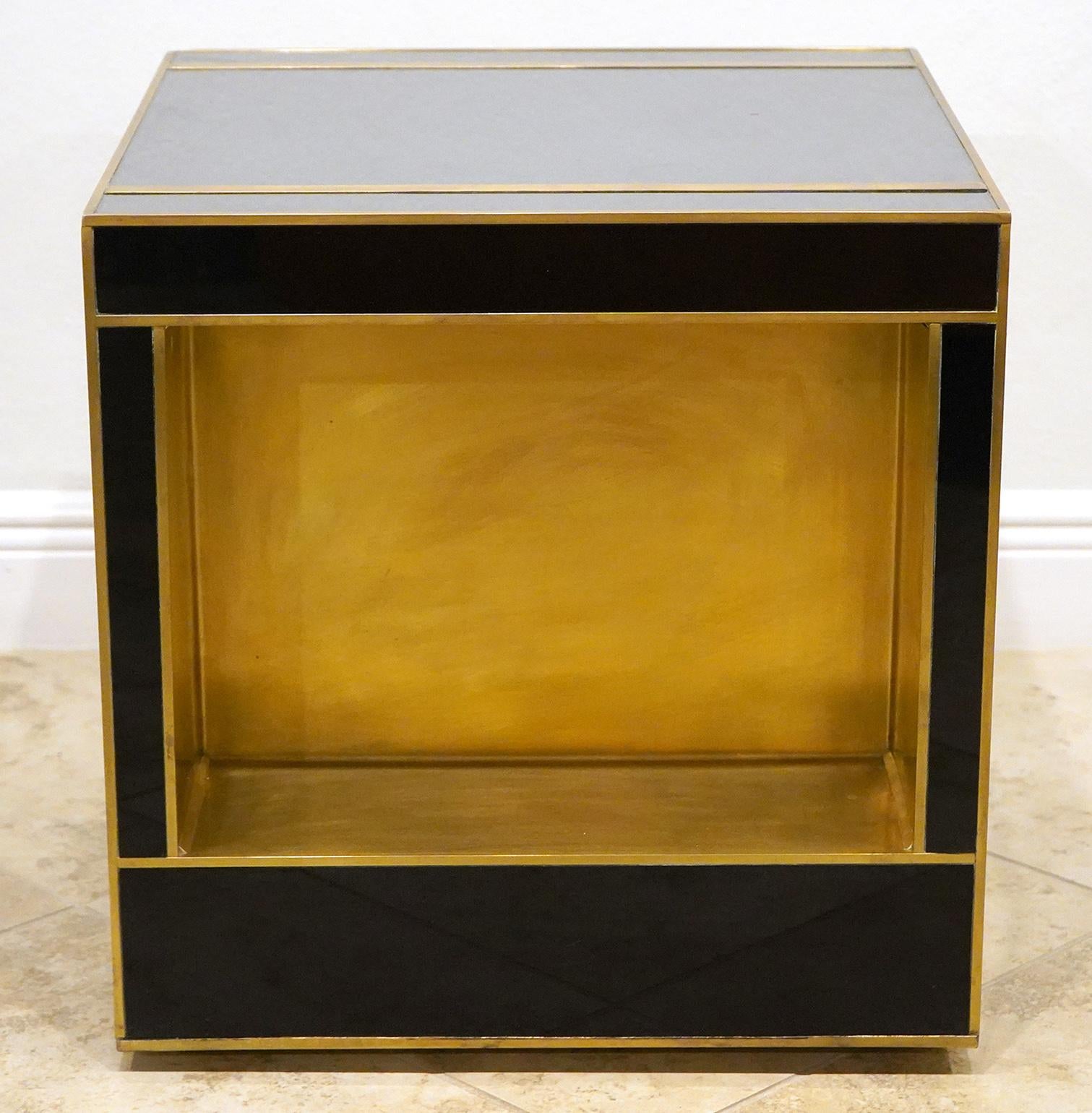 Custom made Italian brass and glass side or end table. Modern cube design with storage cutouts on two sides for storage. Quality made. We have a second table in a different color.