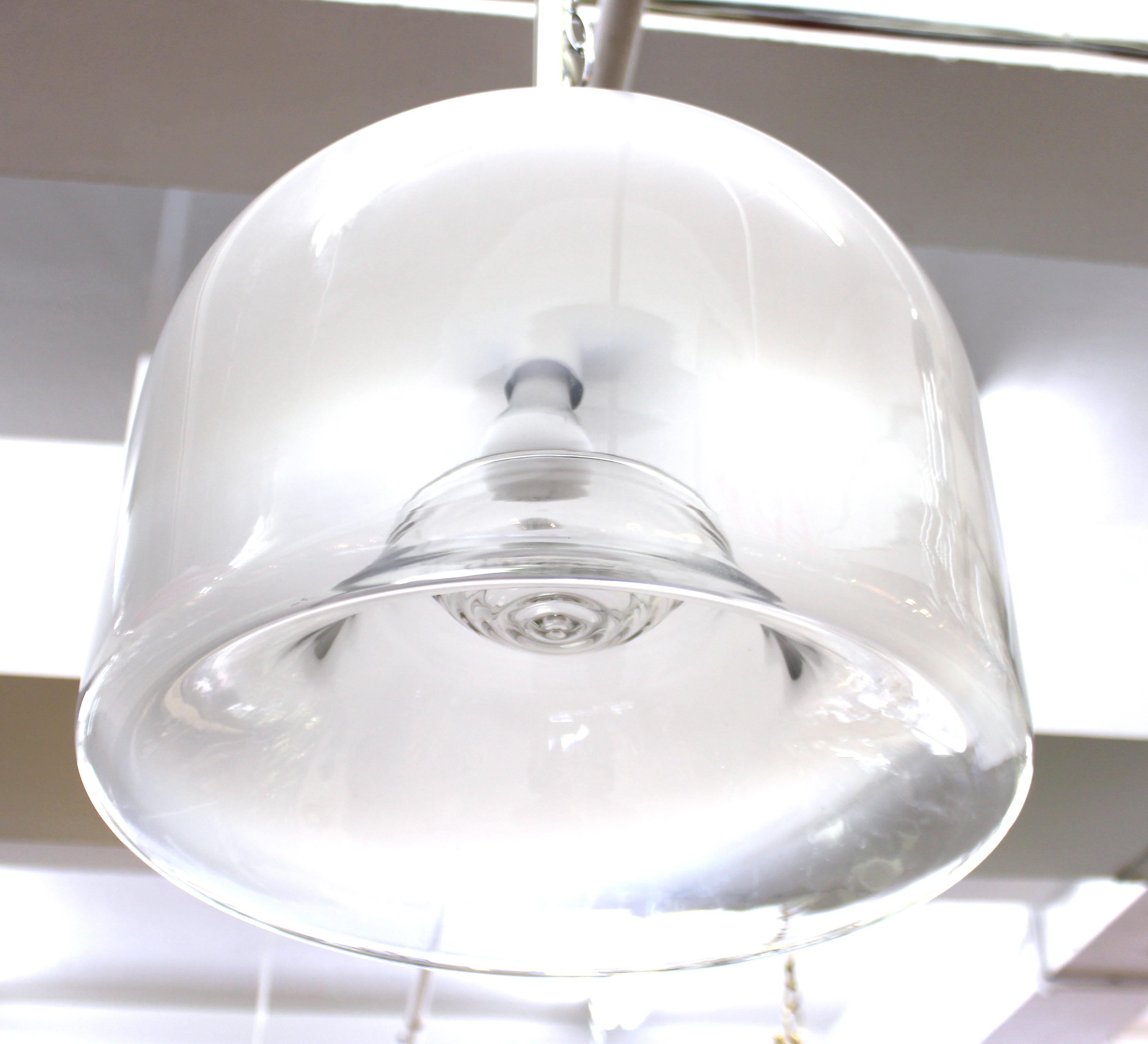 Modern dome glass pendant chandelier with white glass fading into clear glass and a decorative ripple effect of the glass near the light source. The piece has a faded label on the top of the glass dome and is in great vintage condition with