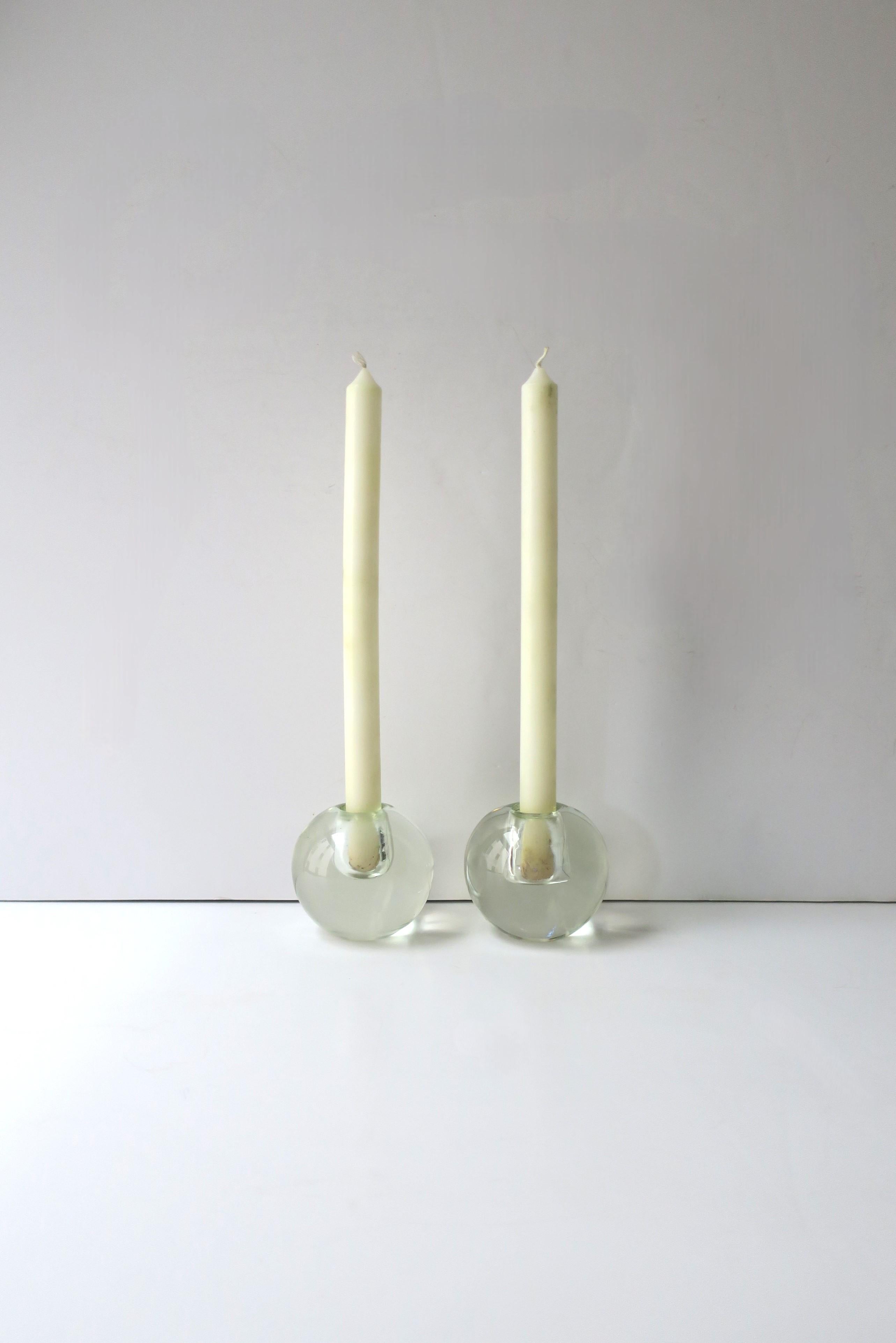 A substantial pair of transparent glass candlestick holders with a round sphere design, in the Modern style, circa mid-late-20th century. Very good condition as shown in images. Dimensions: 3