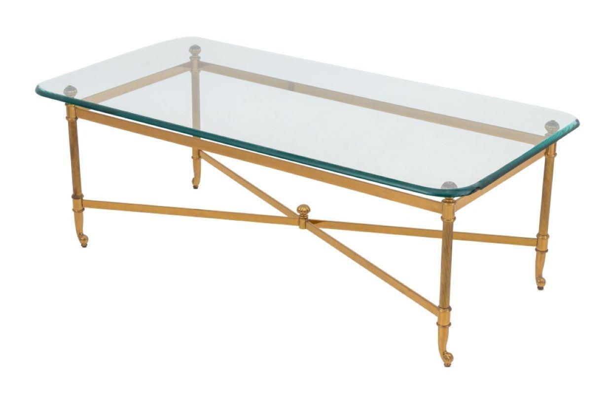 Modern Glass Top Brass Coffee Table, with four column form legs on scroll feet conjoined by X-form stretcher. 16